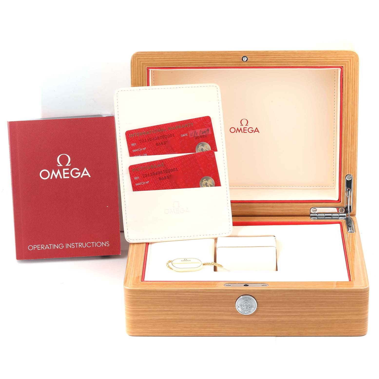 The image shows the packaging, operating instructions, warranty cards, and accessories for the Aqua Terra model by Omega.