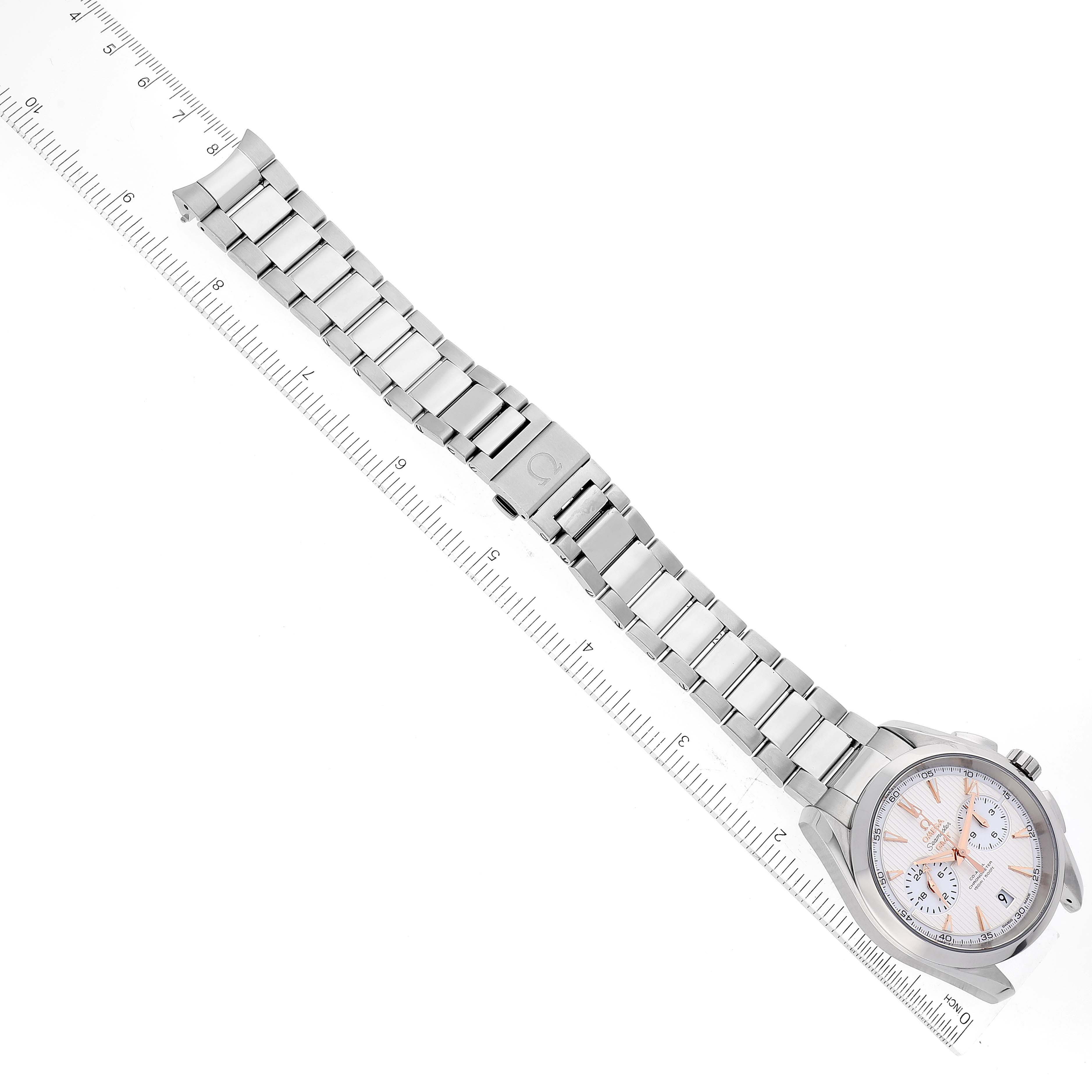 The image shows an Omega Aqua Terra 231.10.43.52.02.001 Men
s Stainless Steel Silver Dial 231.10.43.52.02.001 Men
s Stainless Steel Silver Dial watch from an overhead angle, displaying the full watch face, bracelet, and clasp next to a ruler.