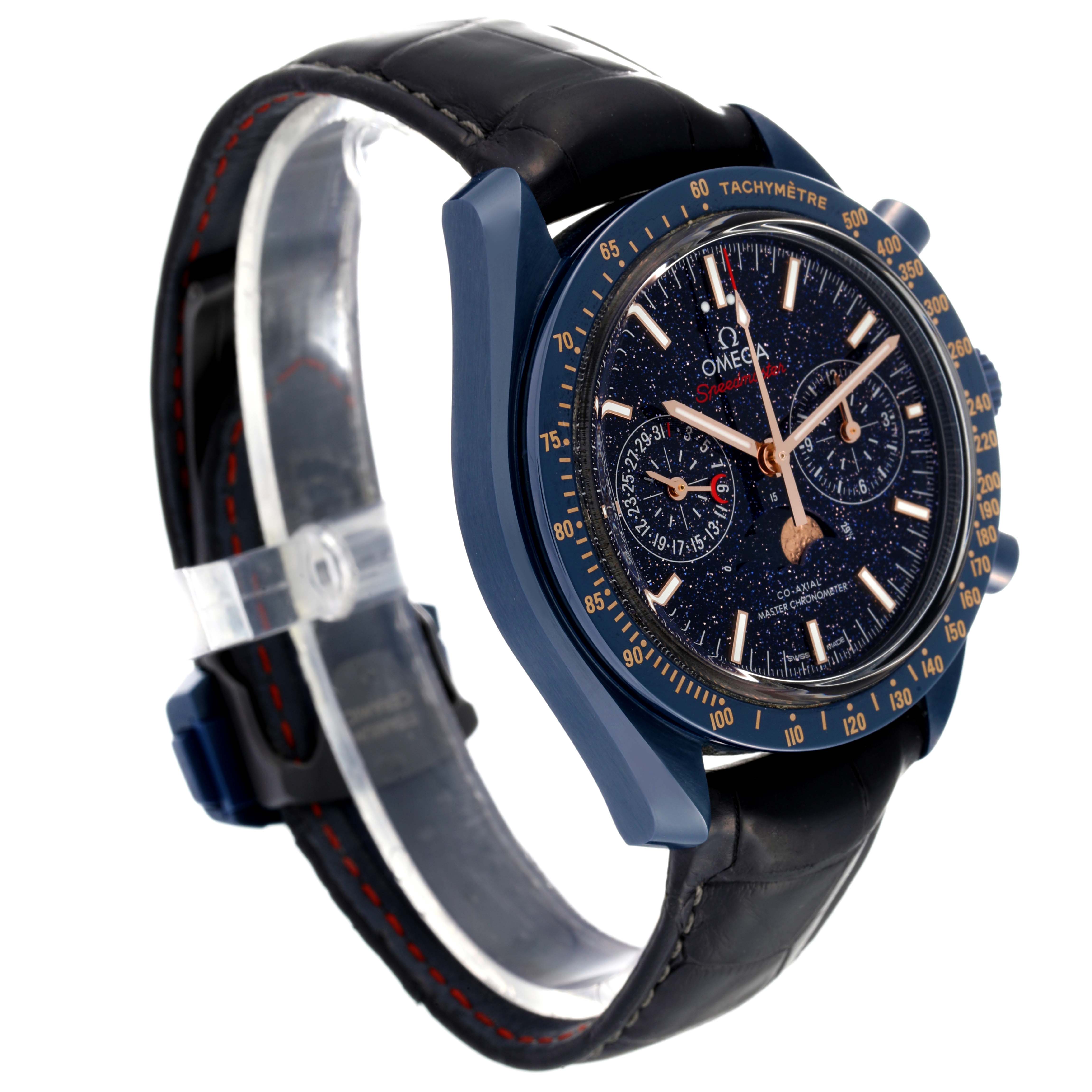The Omega Speedmaster 304.93.44.52.03.002 Men's Ceramic Blue Dial 304.93.44.52.03.002 Men's Ceramic Blue Dial watch is shown at an angle, revealing its dial, tachymeter bezel, and leather strap.