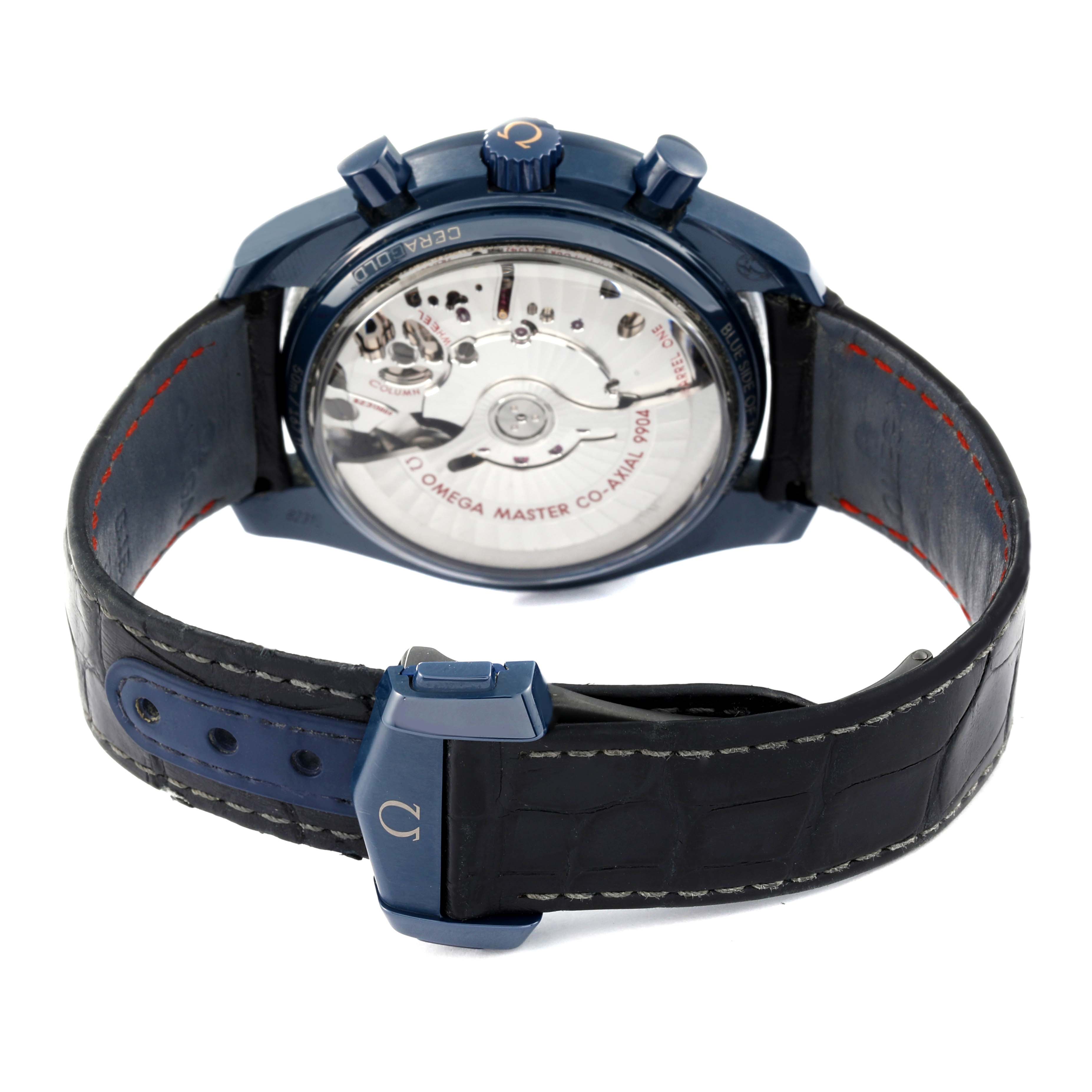 The image shows the back view of an Omega Speedmaster 304.93.44.52.03.002 Men's Ceramic Blue Dial 304.93.44.52.03.002 Men's Ceramic Blue Dial watch highlighting its movement and blue strap.