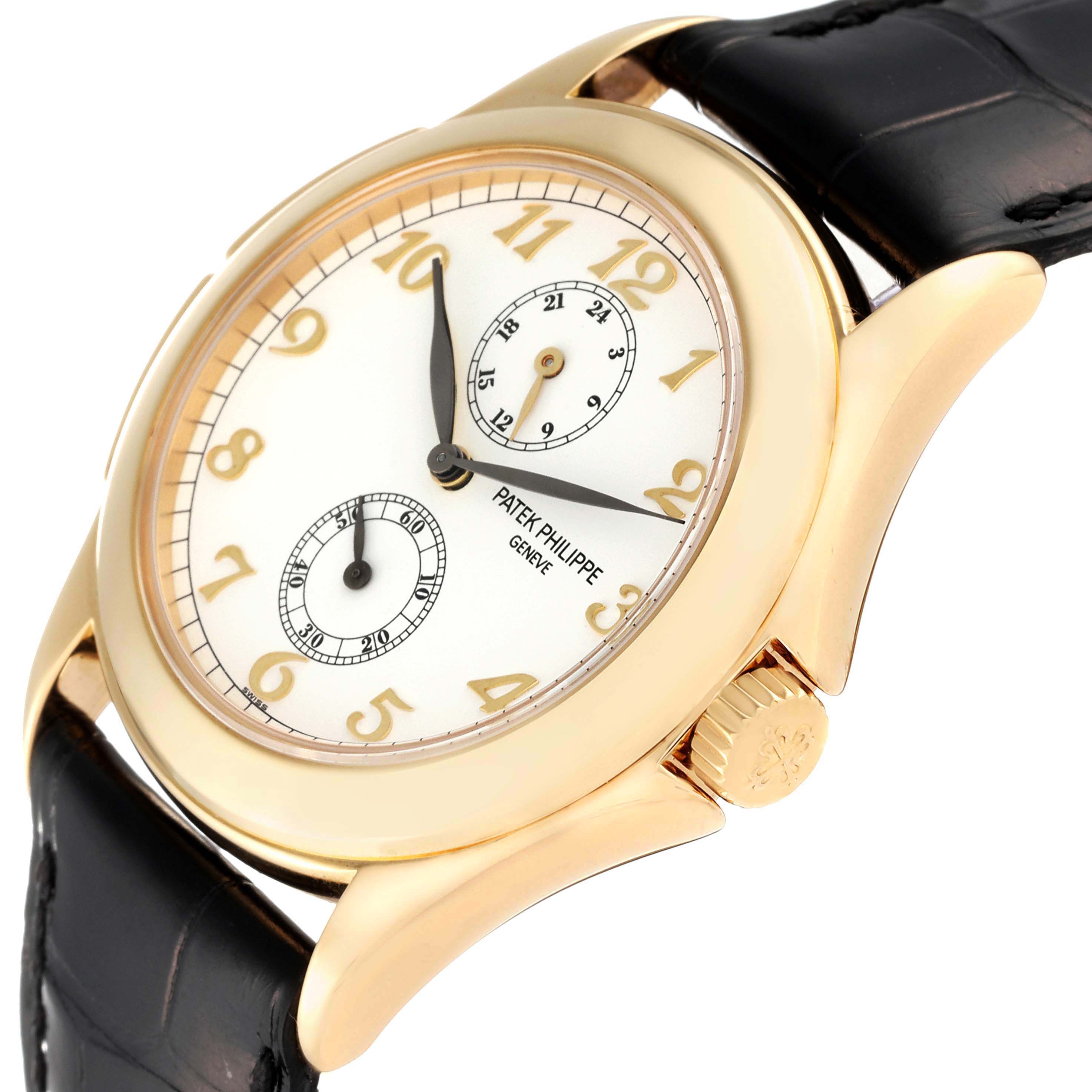 The image shows a close-up of the Patek Philippe Calatrava 5134J Men's Yellow Gold White Dial 5134J Men's Yellow Gold White Dial watch, highlighting its dial, indices, hands, crown, and black leather strap.