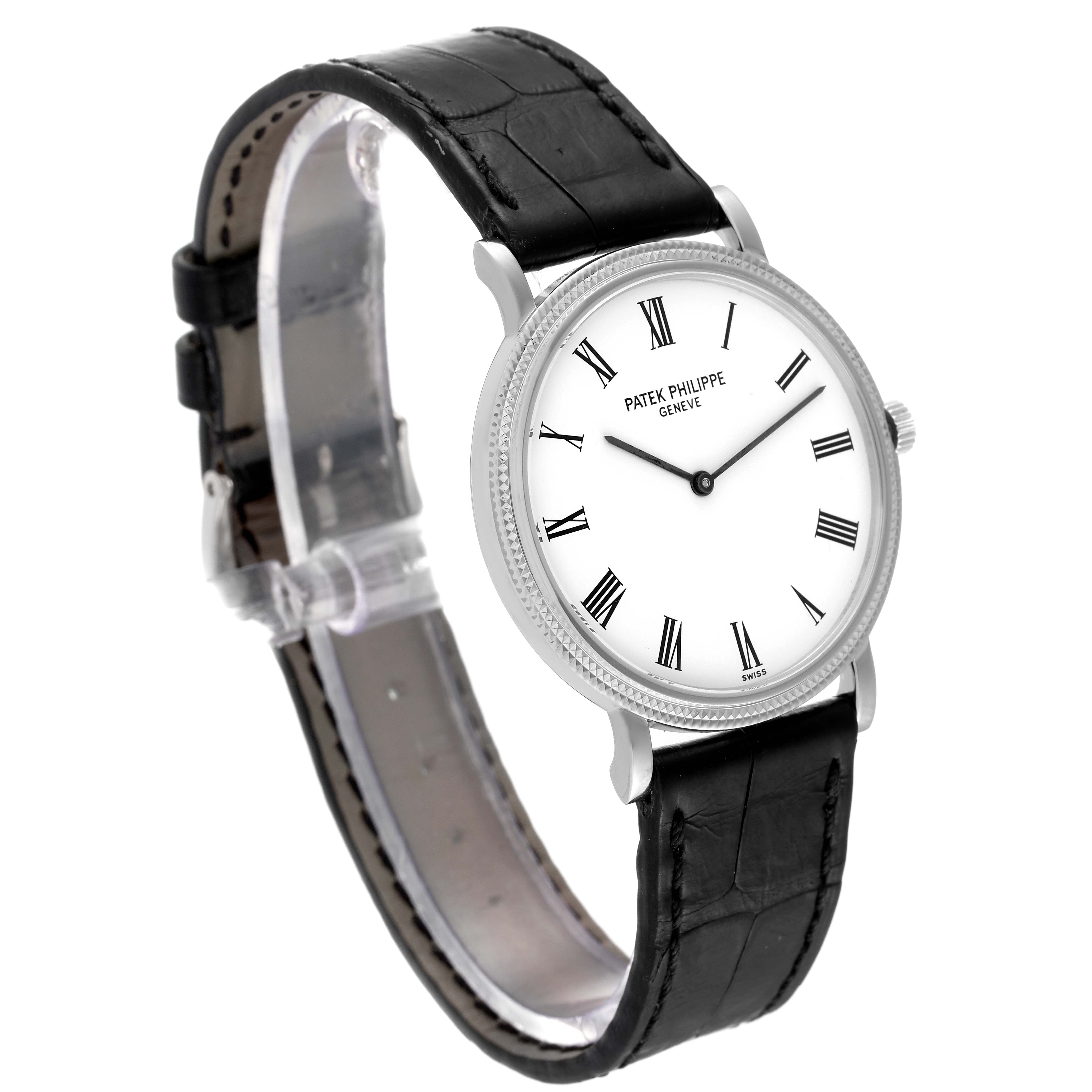 The image shows a Patek Philippe Calatrava 5120G Men
s White Gold White Dial 5120G Men
s White Gold White Dial watch from a front-side angle, highlighting its dial, case, and black leather strap.