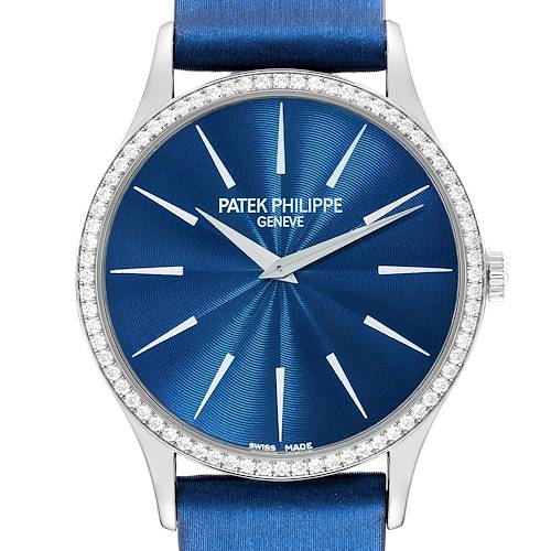 The image shows the face of a Patek Philippe Calatrava watch, focusing on its blue dial, hour markers, and diamond-studded bezel.