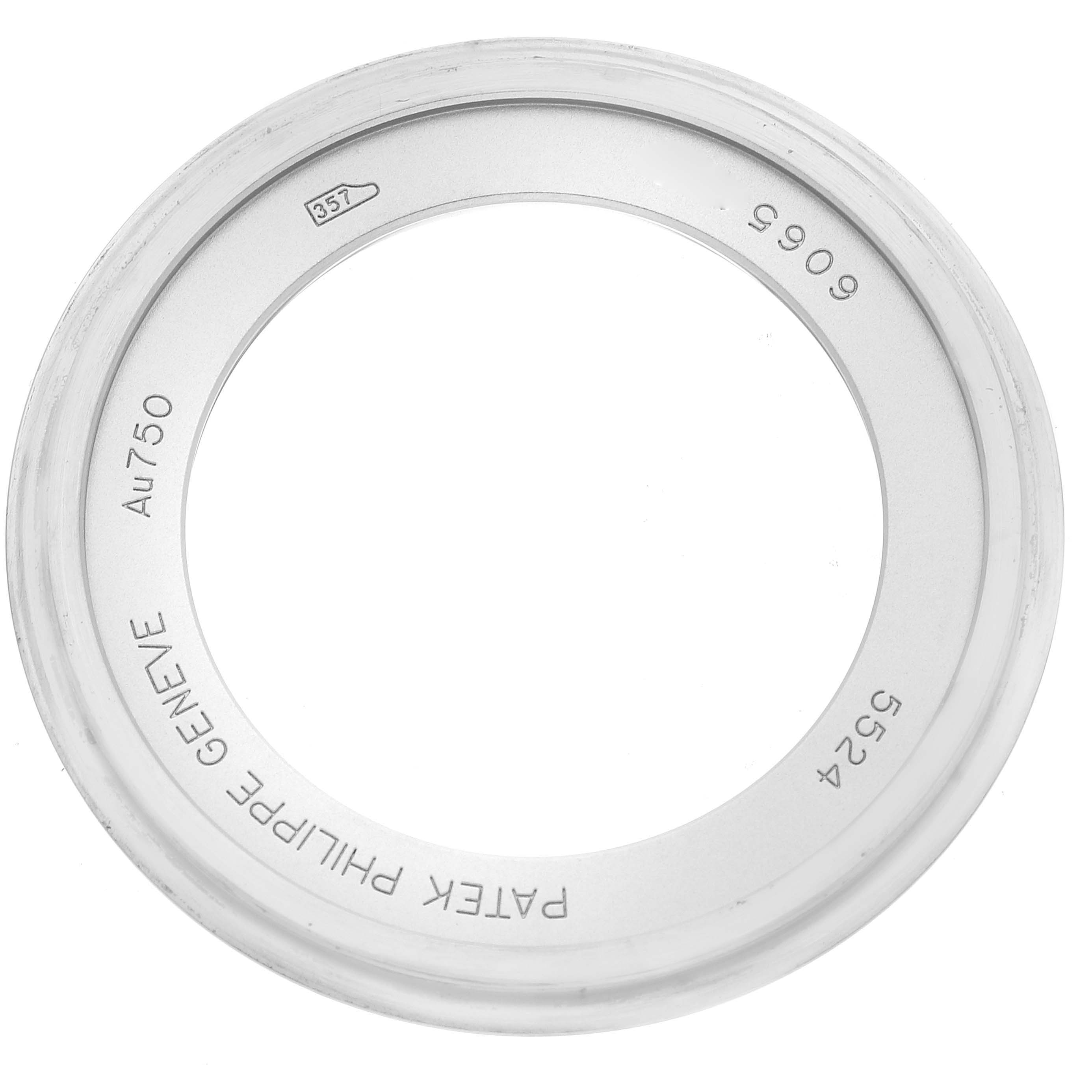 This image shows a Patek Philippe Calatrava 5524G-001 Men's White Gold Blue Dial 5524G-001 Men's White Gold Blue Dial bezel viewed from above, highlighting its inscriptions and markings.