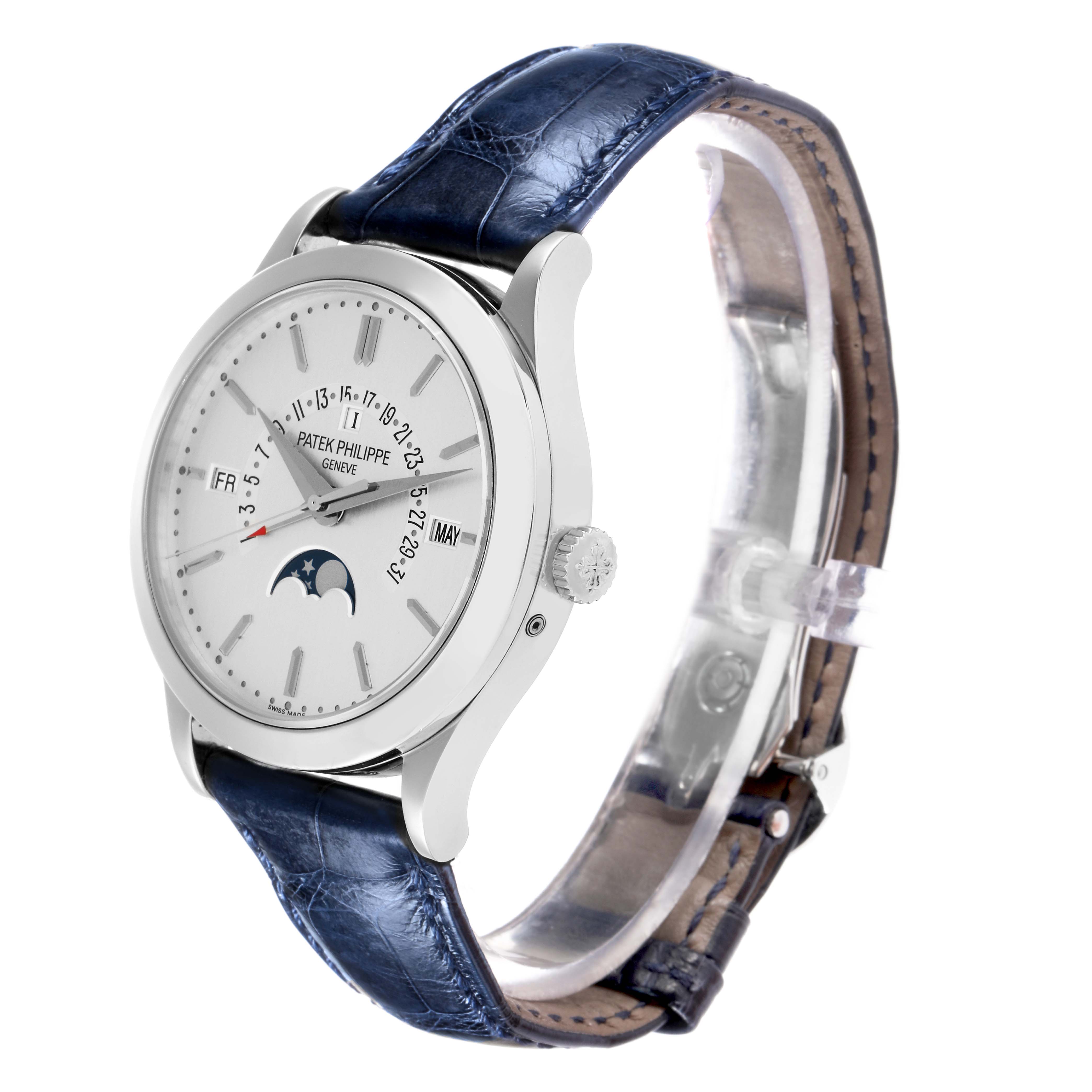 The image shows a Patek Philippe Complications 5496P-004 Men
s Platinum Silver Dial watch at a three-quarter angle, displaying the face, crown, and blue leather strap.