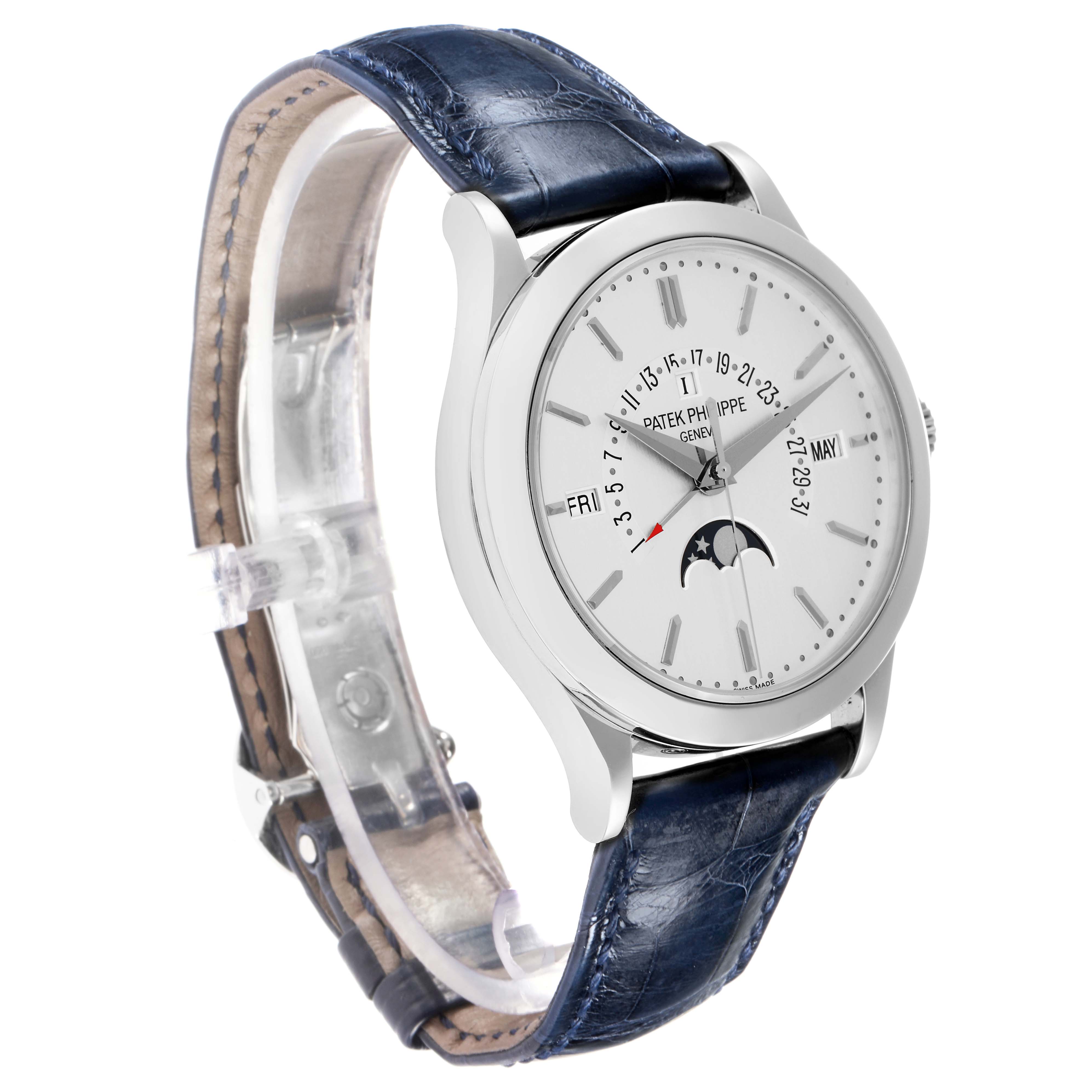 The Patek Philippe Complications 5496P-004 Men
s Platinum Silver Dial watch is shown at a three-quarter angle, displaying the face, blue strap, and clasp.