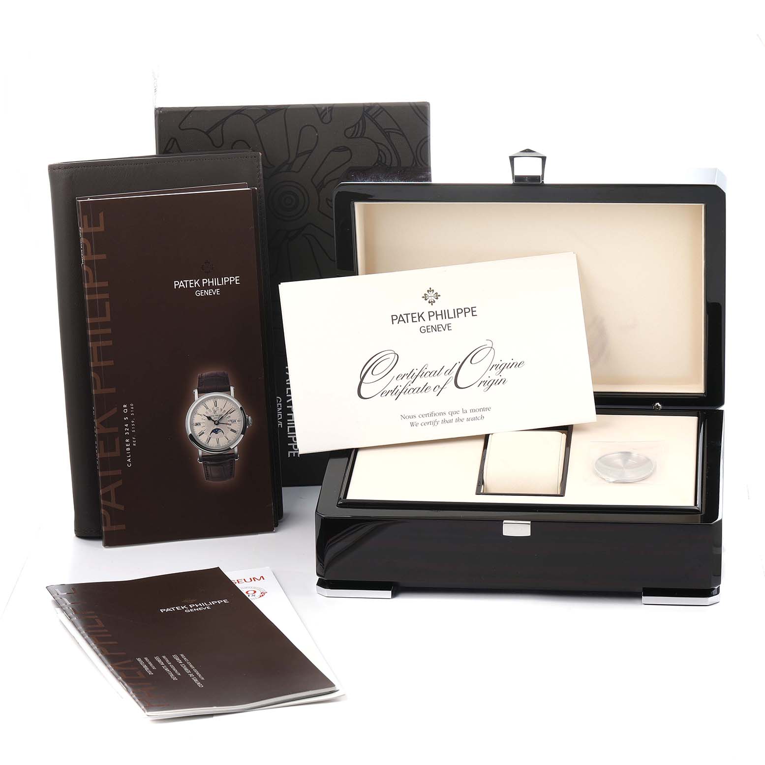 The image shows the packaging and accessories of the Patek Philippe Complications 5496P-004 Men
s Platinum Silver Dial watch, including a box, manuals, and certificate.