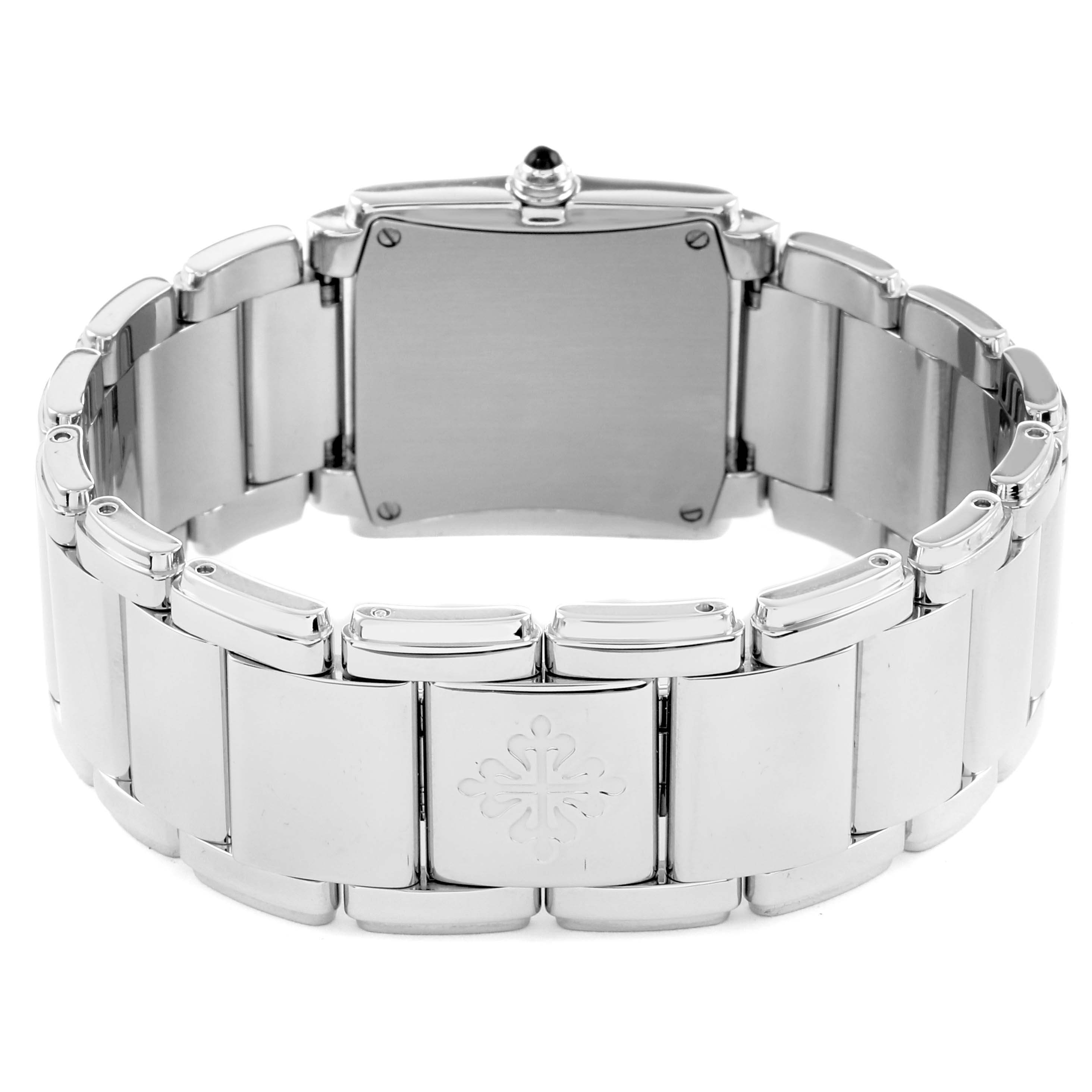 The image shows the back and bracelet of a Patek Philippe Twenty-4 4910 Women
s Stainless Steel Black Dial watch, highlighting the clasp and emblem from a rear angle.