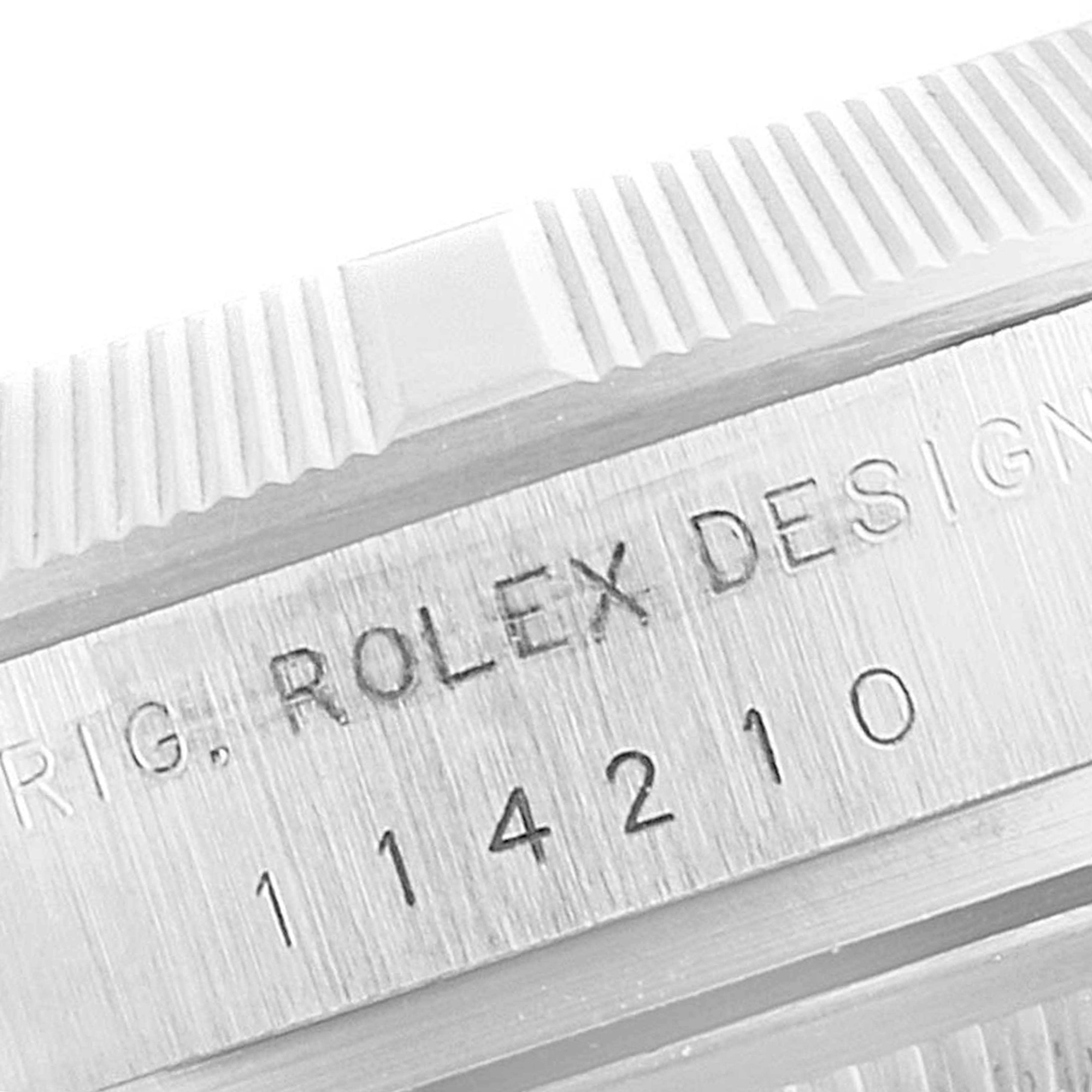 This close-up image shows the edge of the bezel and part of the case of a Rolex Air-King 114210 Men's Stainless Steel White Dial 114210 Men's Stainless Steel White Dial watch, displaying the model number 114210.