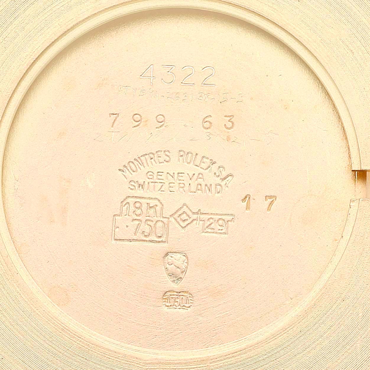 This image shows the inside case back of a Rolex Cellini 4322 Men's Yellow Gold Champagne Dial 4322 Men's Yellow Gold Champagne Dial model watch, highlighting various engravings and hallmarks.