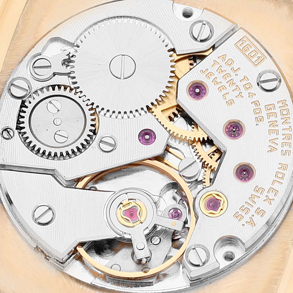 The image shows a close-up view of the mechanical movement of a Rolex Cellini 4322 Men's Yellow Gold Champagne Dial 4322 Men's Yellow Gold Champagne Dial watch, revealing its intricate gears and components.