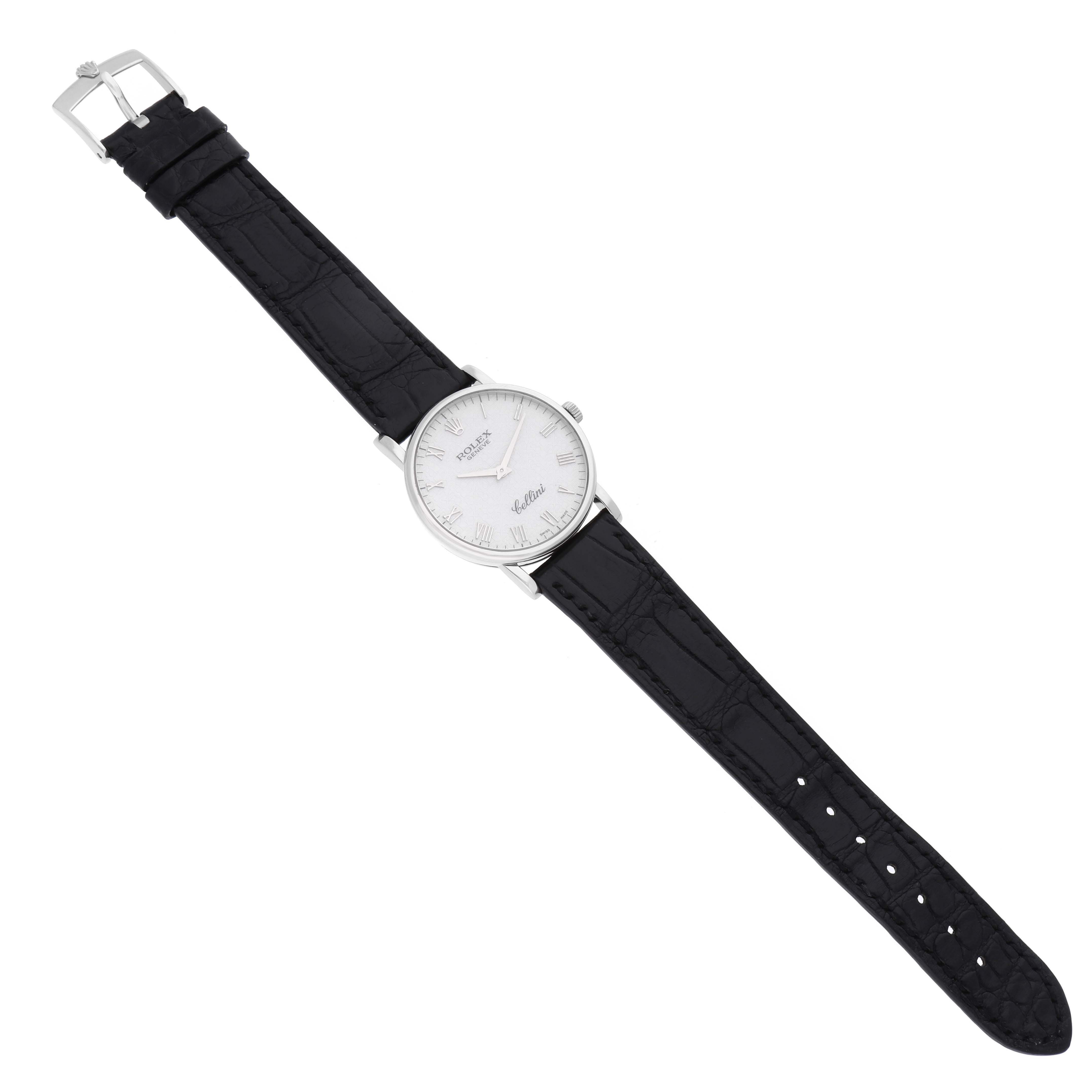 The image shows a Rolex Cellini 5115/9 Men's White Gold Silver Dial 5115/9 Men's White Gold Silver Dial watch from a top-down angle, displaying its face, bezel, and black leather strap.