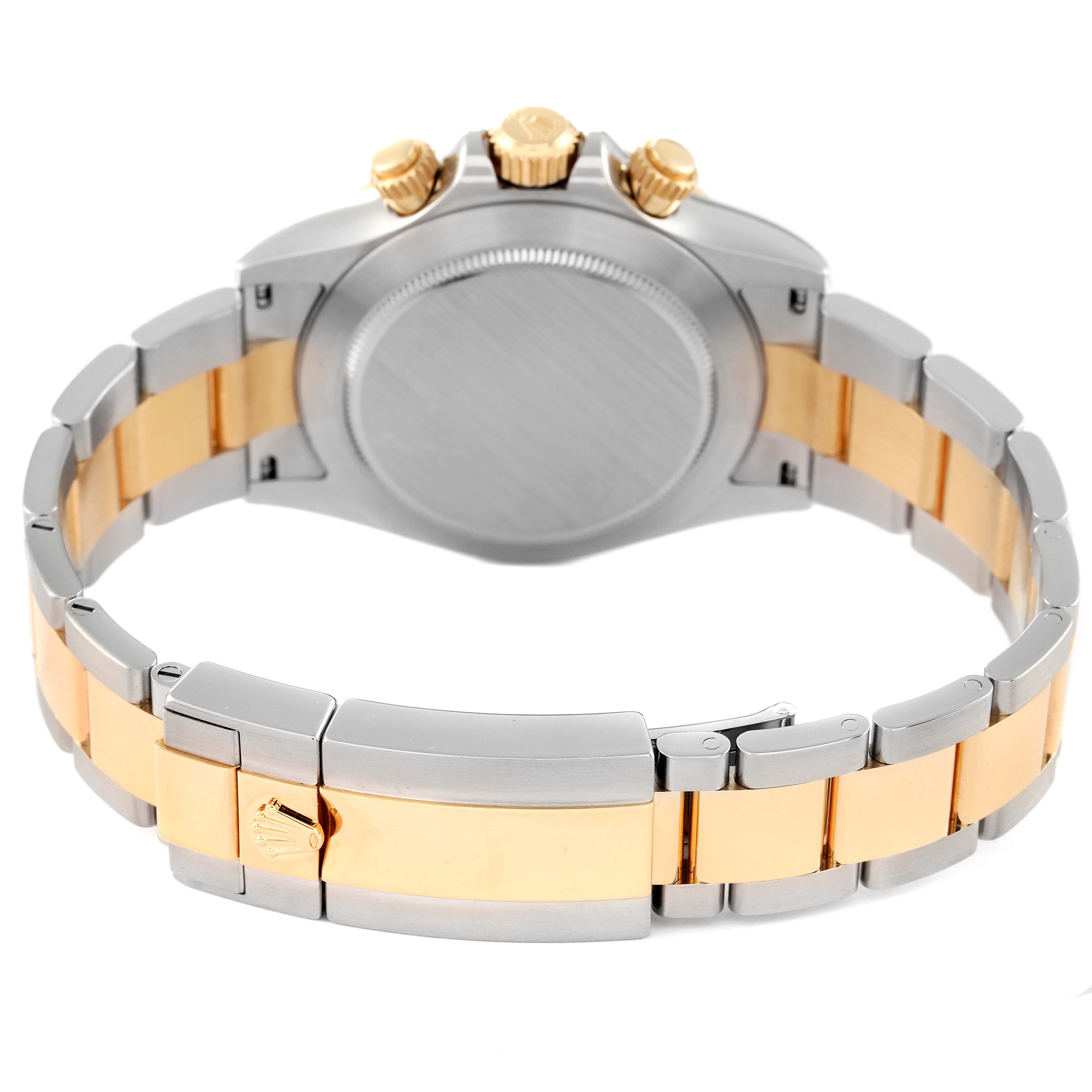 The image shows the back and bracelet of the Rolex Daytona 116503 Men's Steel and Gold (two tone) Black Dial 116503 Men's Steel and Gold (two tone) Black Dial watch at an angle highlighting the clasp and crown.