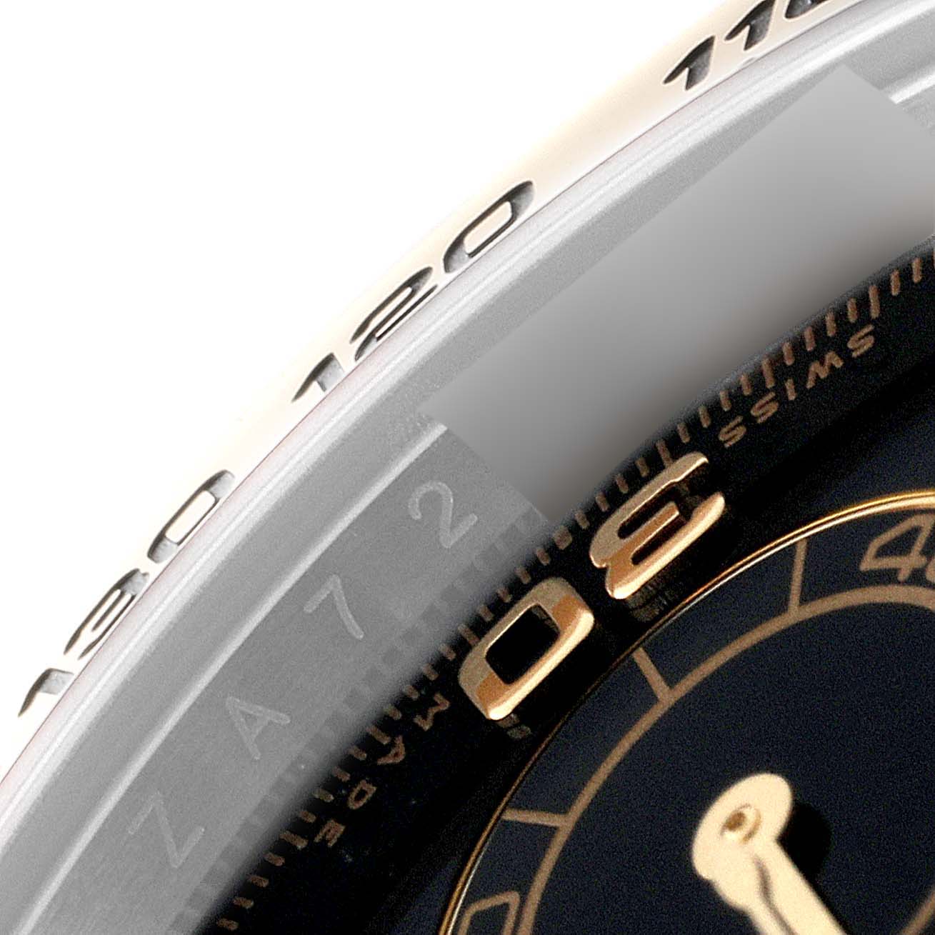 This close-up image shows the bezel and part of the dial of a Rolex Daytona 116503 Men's Steel and Gold (two tone) Black Dial 116503 Men's Steel and Gold (two tone) Black Dial watch.