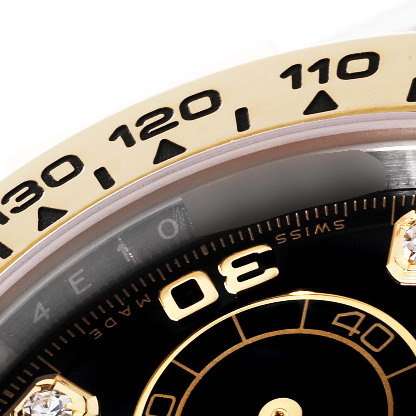 This close-up image shows the bezel and a portion of the dial of a Rolex Daytona 116503 Men's Steel and Gold (two tone) Black Dial 116503 Men's Steel and Gold (two tone) Black Dial watch, highlighting the tachymeter scale and part of the minute markers.