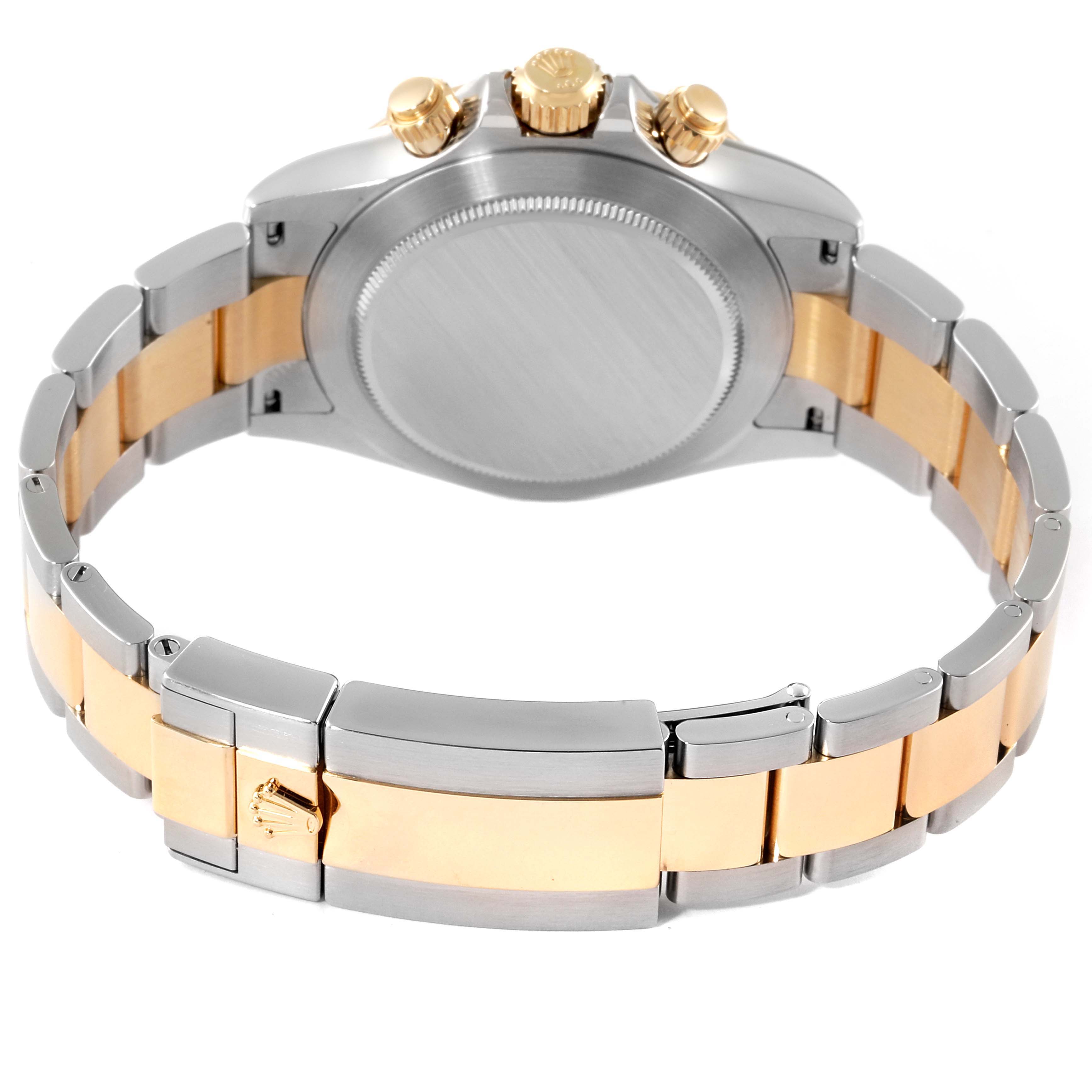 The image shows the back case and bracelet of a Rolex Daytona 116503 Men
s Steel and Gold (two tone) White Dial 116503 Men
s Steel and Gold (two tone) White Dial watch, highlighting its two-tone metal design and clasp.