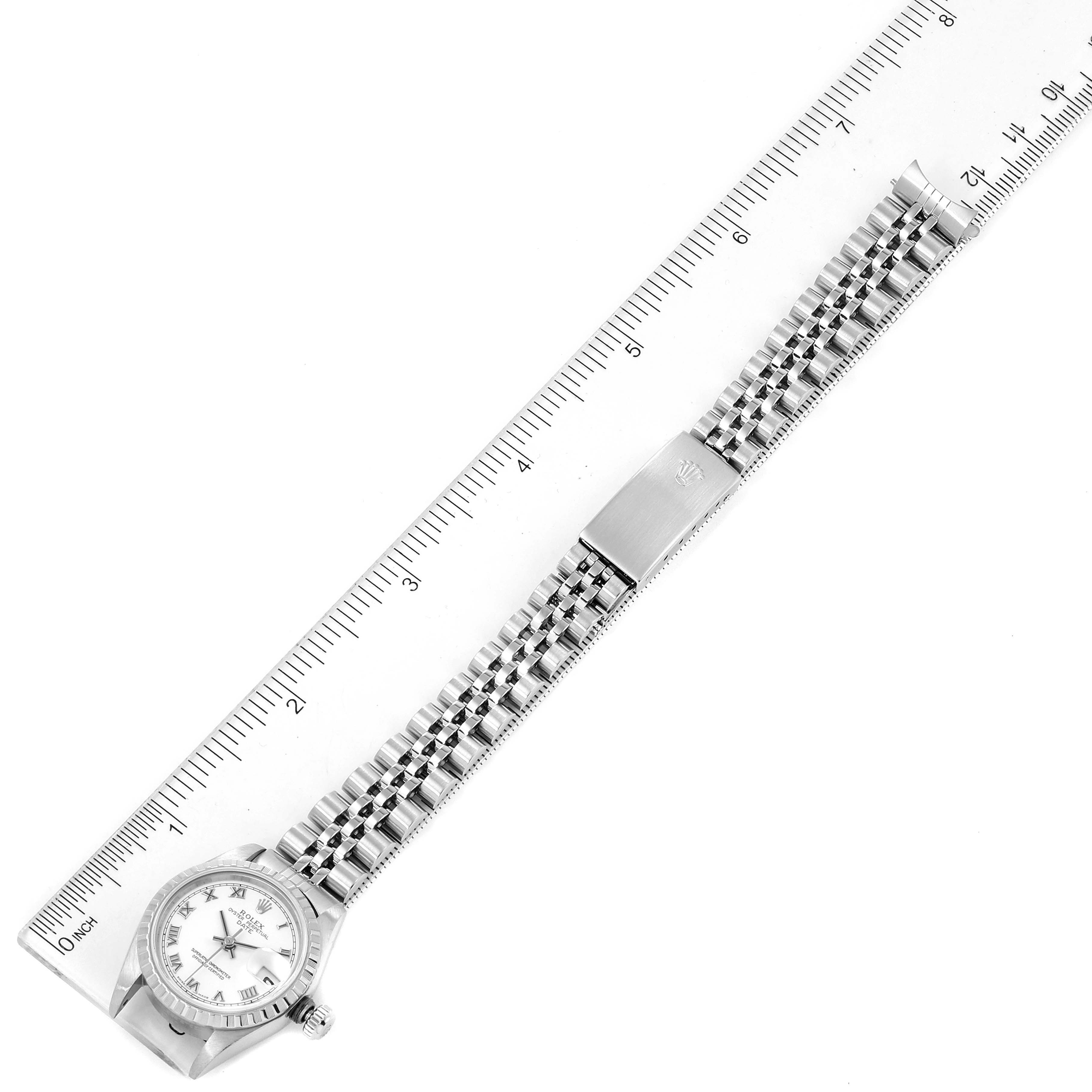 The image shows a top-down view of a Rolex Date 79240 Women
s Stainless Steel White Dial 79240 Women
s Stainless Steel White Dial model watch with a ruler indicating its length.