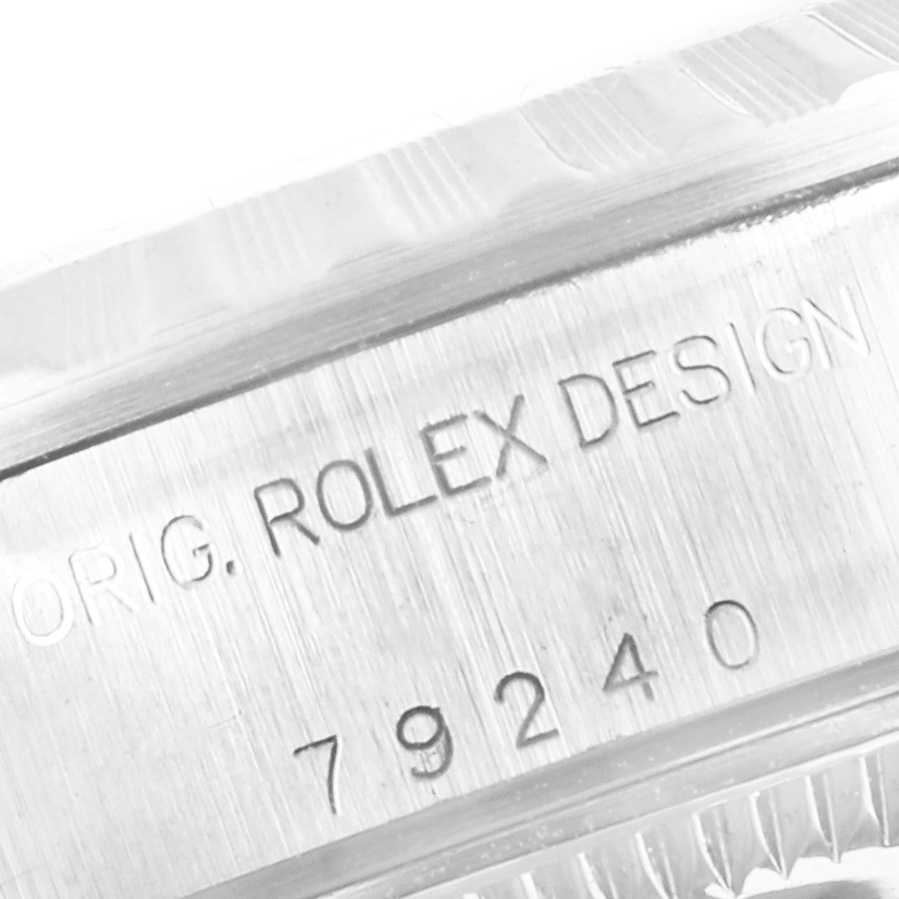 This close-up image shows the model number and design engraving on the side of a Rolex Date 79240 Women
s Stainless Steel White Dial 79240 Women
s Stainless Steel White Dial watch case.