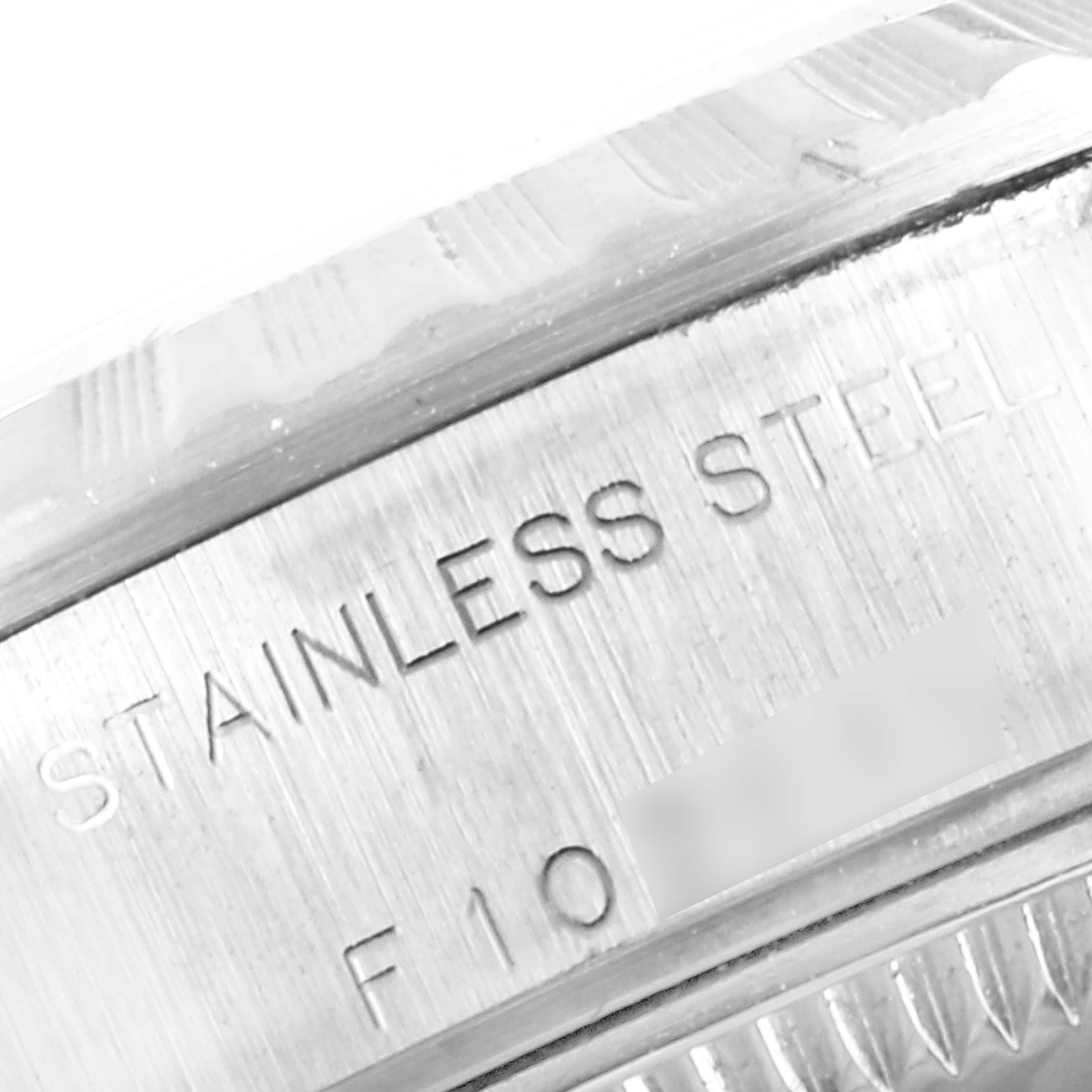 This close-up image shows the side of the stainless steel casing of a Rolex Date 79240 Women
s Stainless Steel White Dial 79240 Women
s Stainless Steel White Dial model watch.