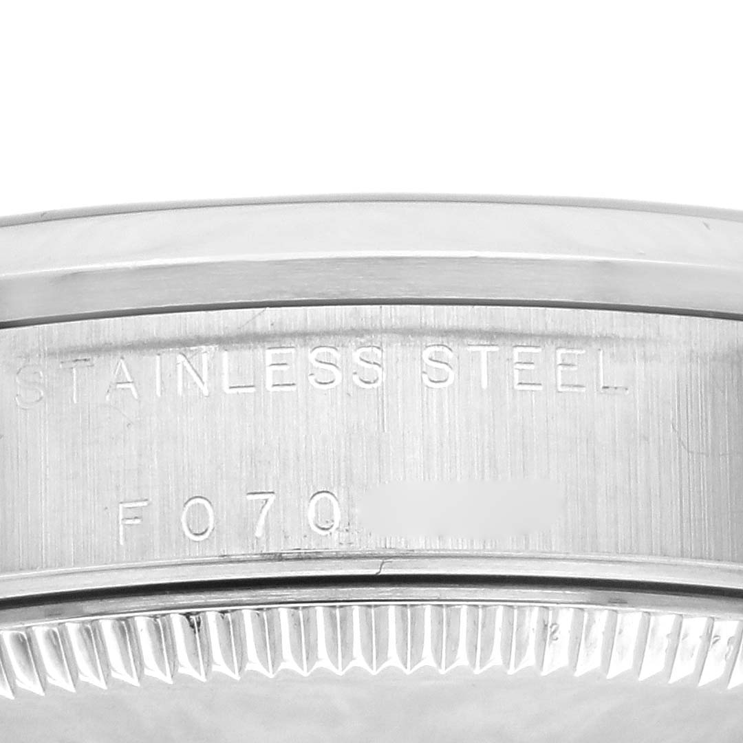 The image shows a close-up of the case back edge of a Rolex Mid-Size 78240 Women's Stainless Steel Silver Dial 78240 Women's Stainless Steel Silver Dial watch, displaying "STAINLESS STEEL" and part of the serial number.