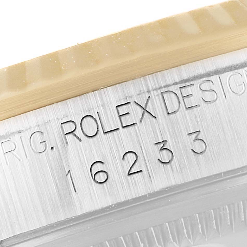 The image shows a close-up of the serial number and design engraving on the case side of a Rolex Datejust 16233 Men's Steel and Gold (two tone) Blue Dial 16233 Men's Steel and Gold (two tone) Blue Dial watch.