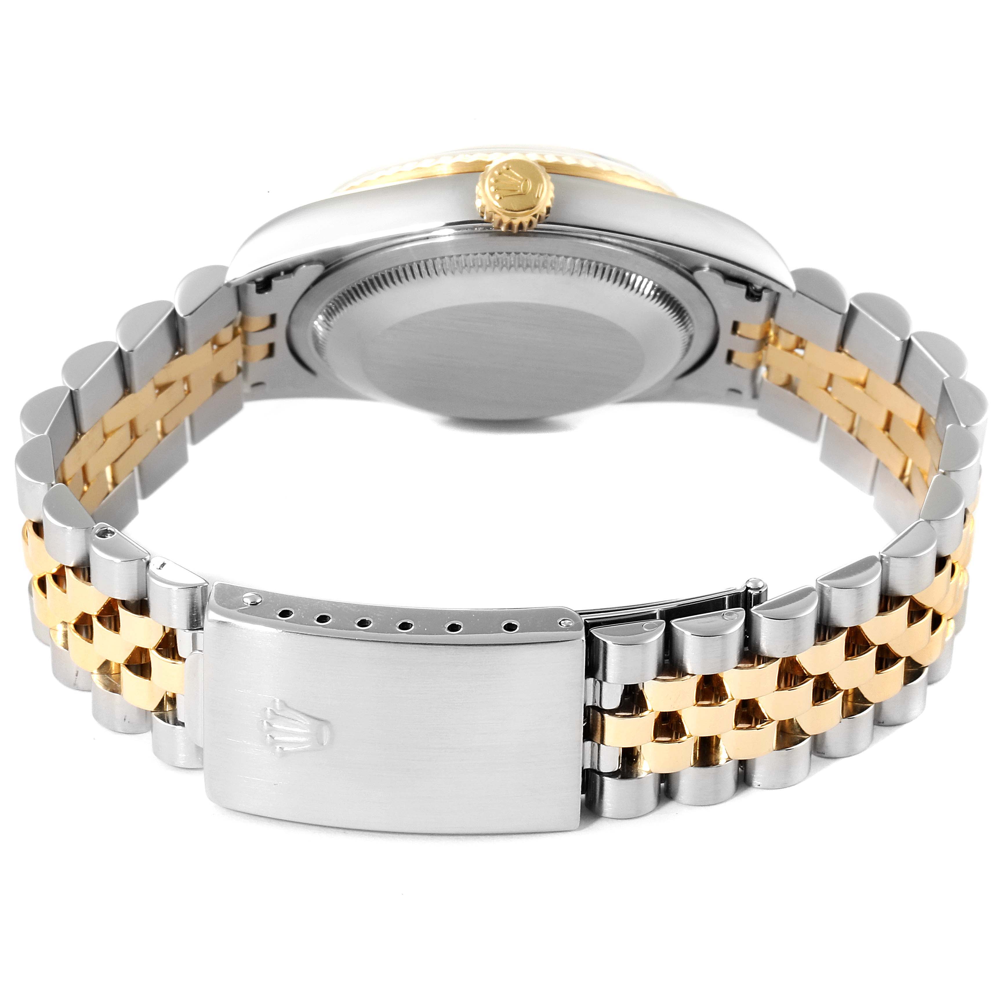 The image shows the back view of a Rolex Datejust 16233 Men's Steel and Gold (two tone) Blue Dial 16233 Men's Steel and Gold (two tone) Blue Dial watch, highlighting the clasp, bracelet, and case back.