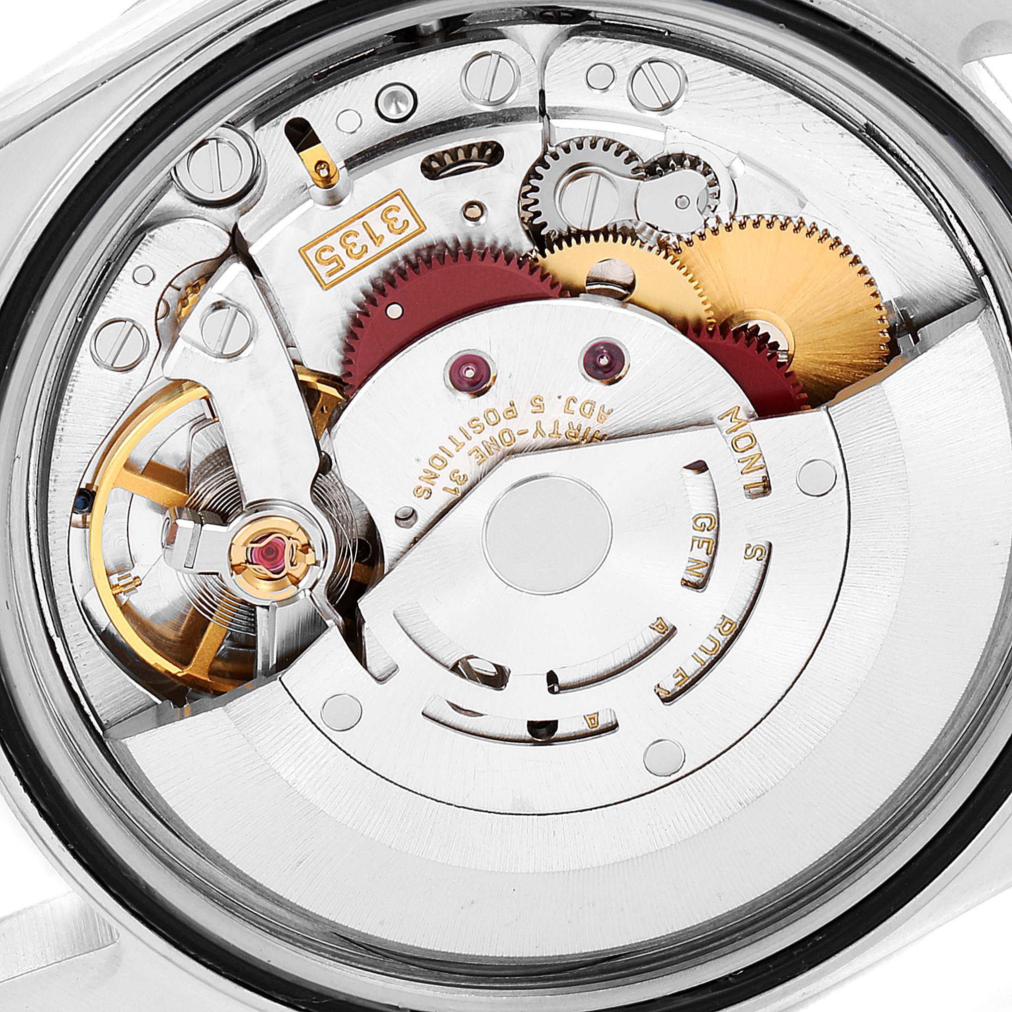 This image shows the intricate internal mechanics of the Rolex Datejust 16233 Men's Steel and Gold (two tone) Blue Dial 16233 Men's Steel and Gold (two tone) Blue Dial watch, focusing on its movement and gears from a close-up angle.