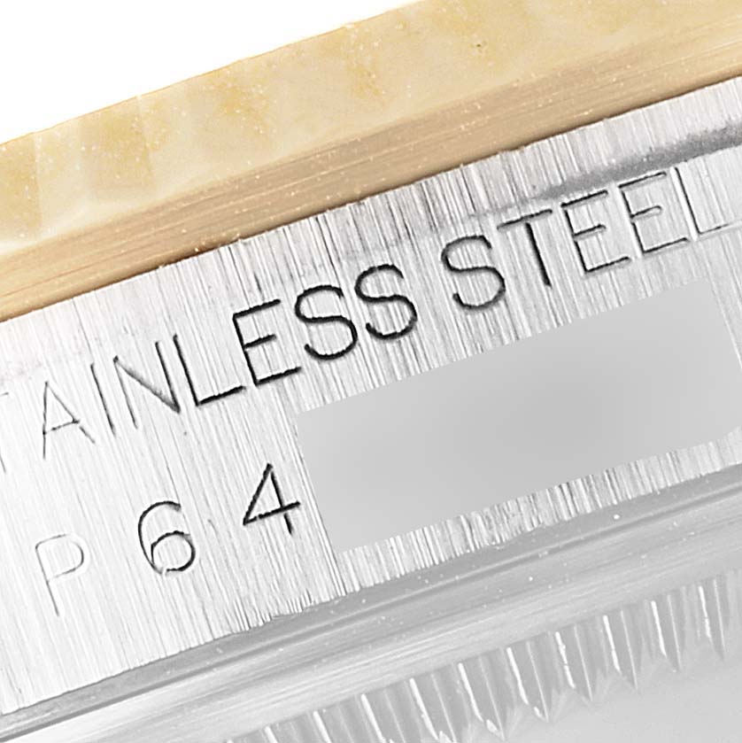 This close-up image of a Rolex Datejust 16233 Men's Steel and Gold (two tone) Blue Dial 16233 Men's Steel and Gold (two tone) Blue Dial watch displays part of the case back with "STAINLESS STEEL" engraving.