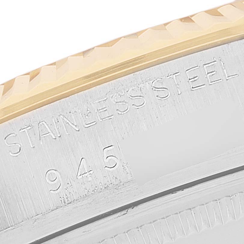 This image shows a close-up of the Rolex Datejust 16013 Men
s Steel and Gold (two tone) Champagne Dial 16013 Men
s Steel and Gold (two tone) Champagne Dial
s stainless steel case with partial engravings.