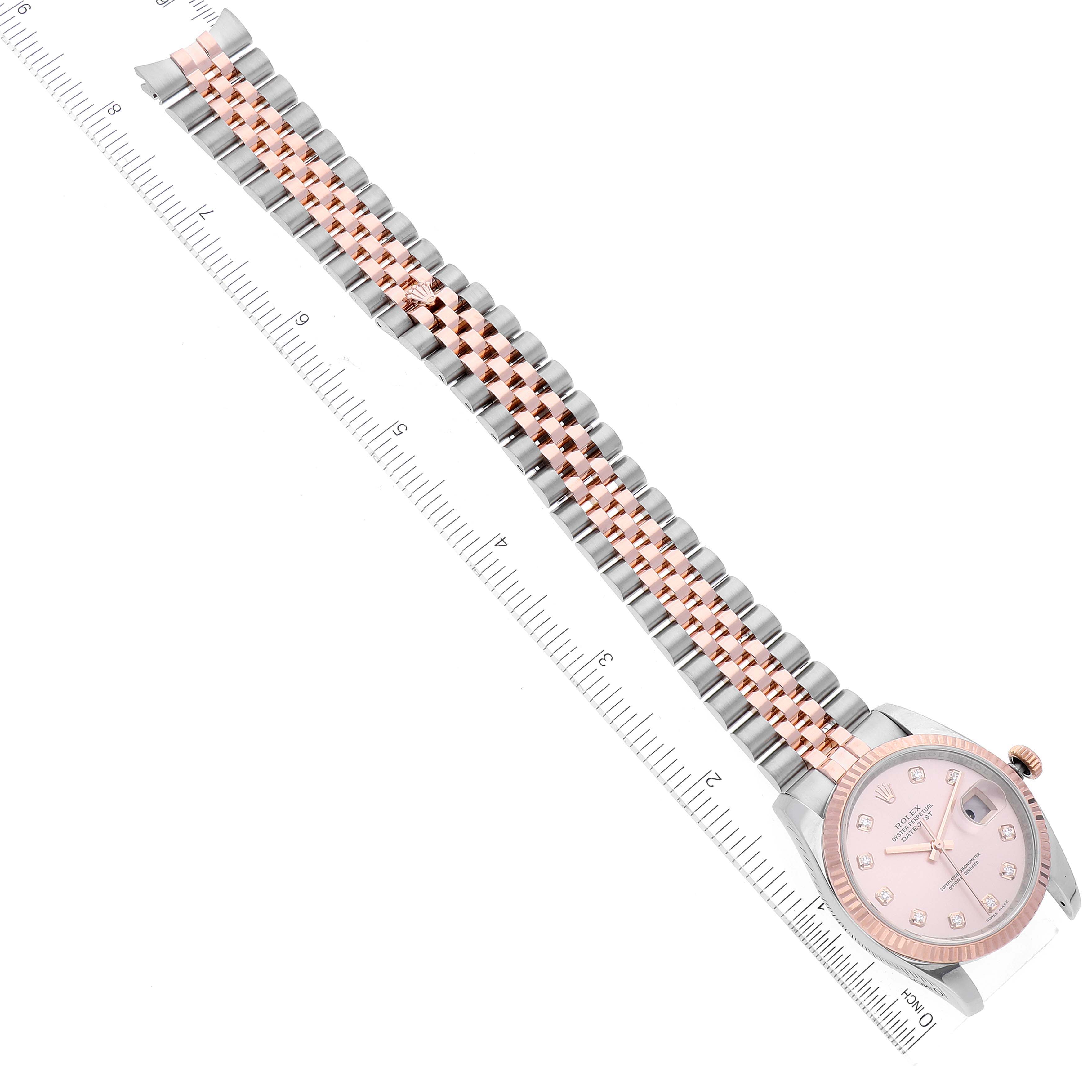 The image shows the Rolex Datejust 116231 Men's Steel and Gold (two tone) Pink Dial 116231 Men's Steel and Gold (two tone) Pink Dial model watch laid flat next to a measuring ruler, showcasing the face and entire band.