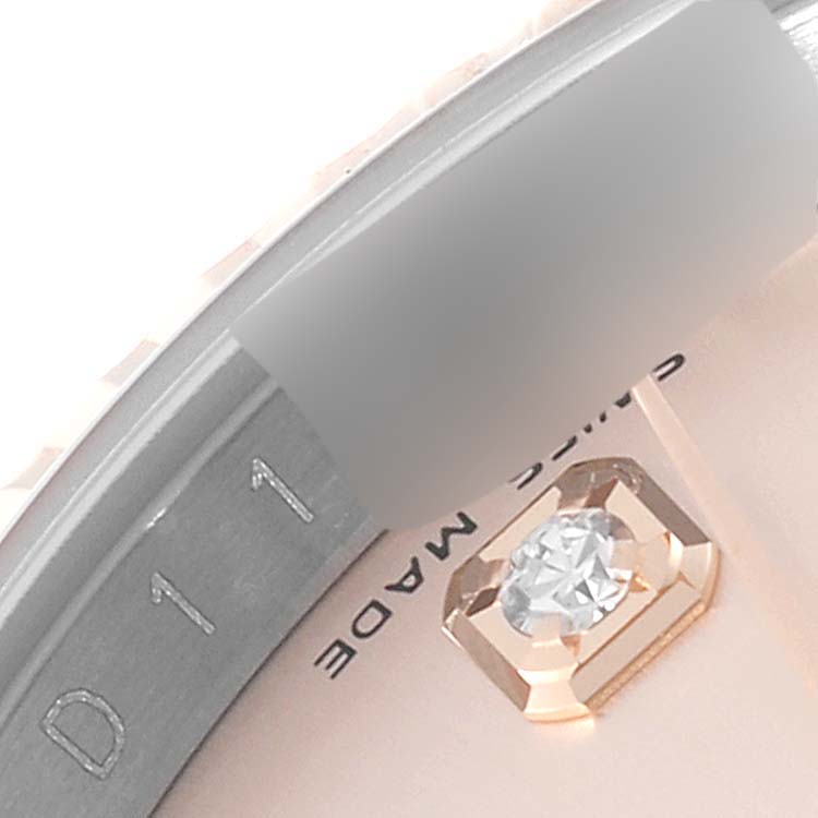 This close-up image shows part of the dial and a diamond hour marker of a Rolex Datejust 116231 Men's Steel and Gold (two tone) Pink Dial 116231 Men's Steel and Gold (two tone) Pink Dial watch.
