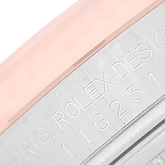 This close-up image of a Rolex Datejust 116231 Men's Steel and Gold (two tone) Pink Dial 116231 Men's Steel and Gold (two tone) Pink Dial shows the engraved details on the side of the watch bezel.