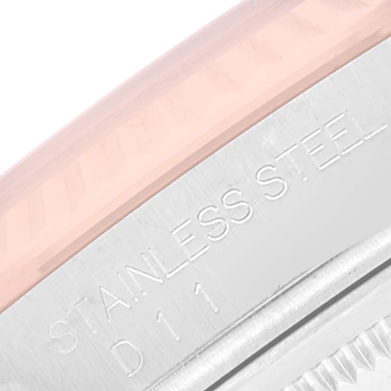This image shows a close-up view of the stainless steel part and edge of the bezel of a Rolex Datejust 116231 Men's Steel and Gold (two tone) Pink Dial 116231 Men's Steel and Gold (two tone) Pink Dial watch.
