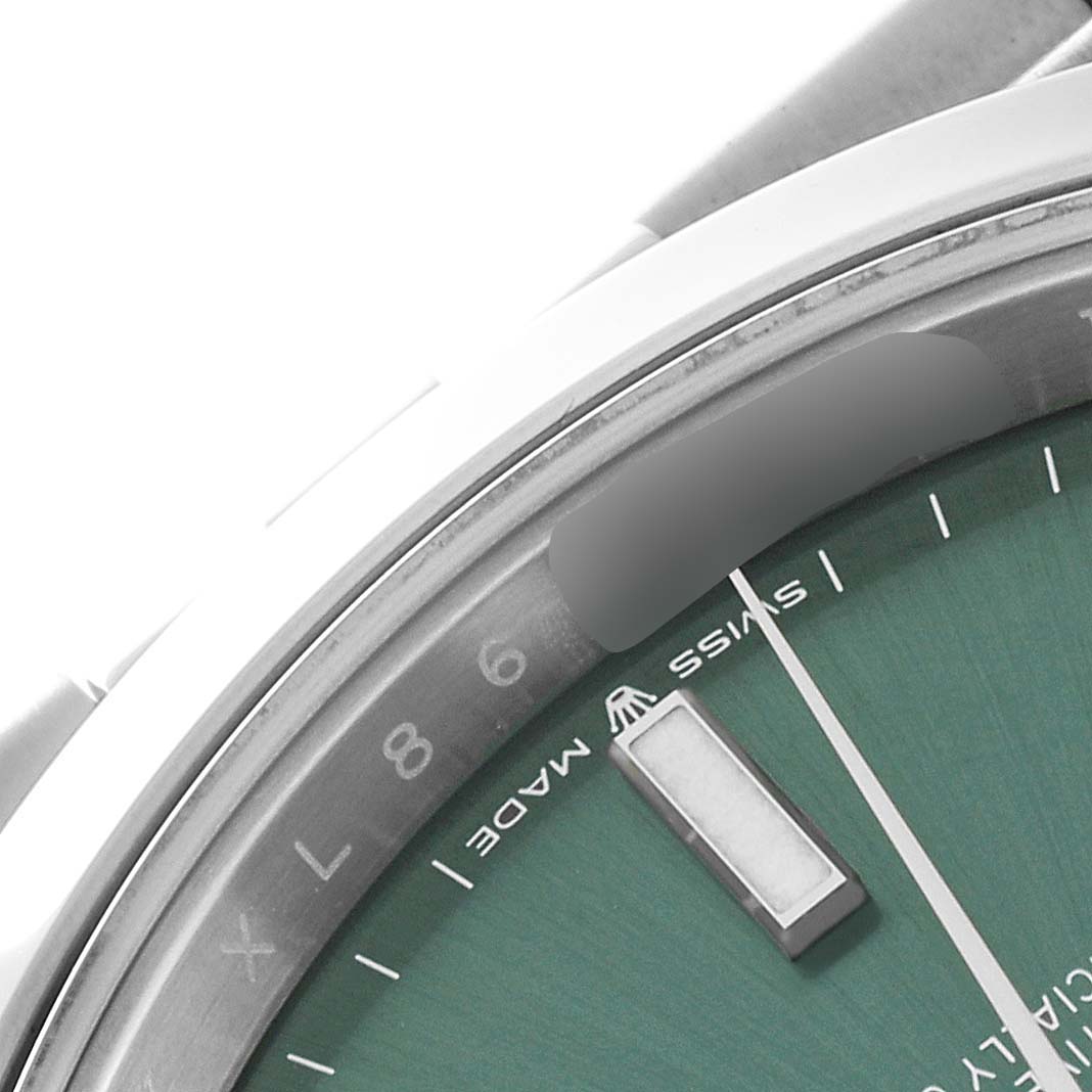 This close-up image of the Rolex Datejust 41 126300 Men
s Stainless Steel Green Dial 126300 Men
s Stainless Steel Green Dial watch shows part of the green dial and "Swiss Made" text.