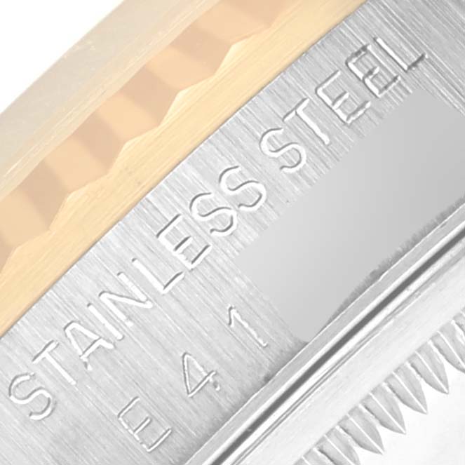 This image shows a close-up view of the stainless steel case and fluted bezel of a Rolex Datejust 16233 Men's Steel and Gold (two tone) Black Dial 16233 Men's Steel and Gold (two tone) Black Dial watch.