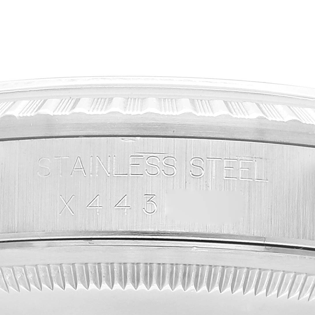 The image shows a close-up of the side of the case of a Rolex Datejust 16220 Men's Stainless Steel Blue Dial 16220 Men's Stainless Steel Blue Dial watch, focusing on the stainless steel engravings.