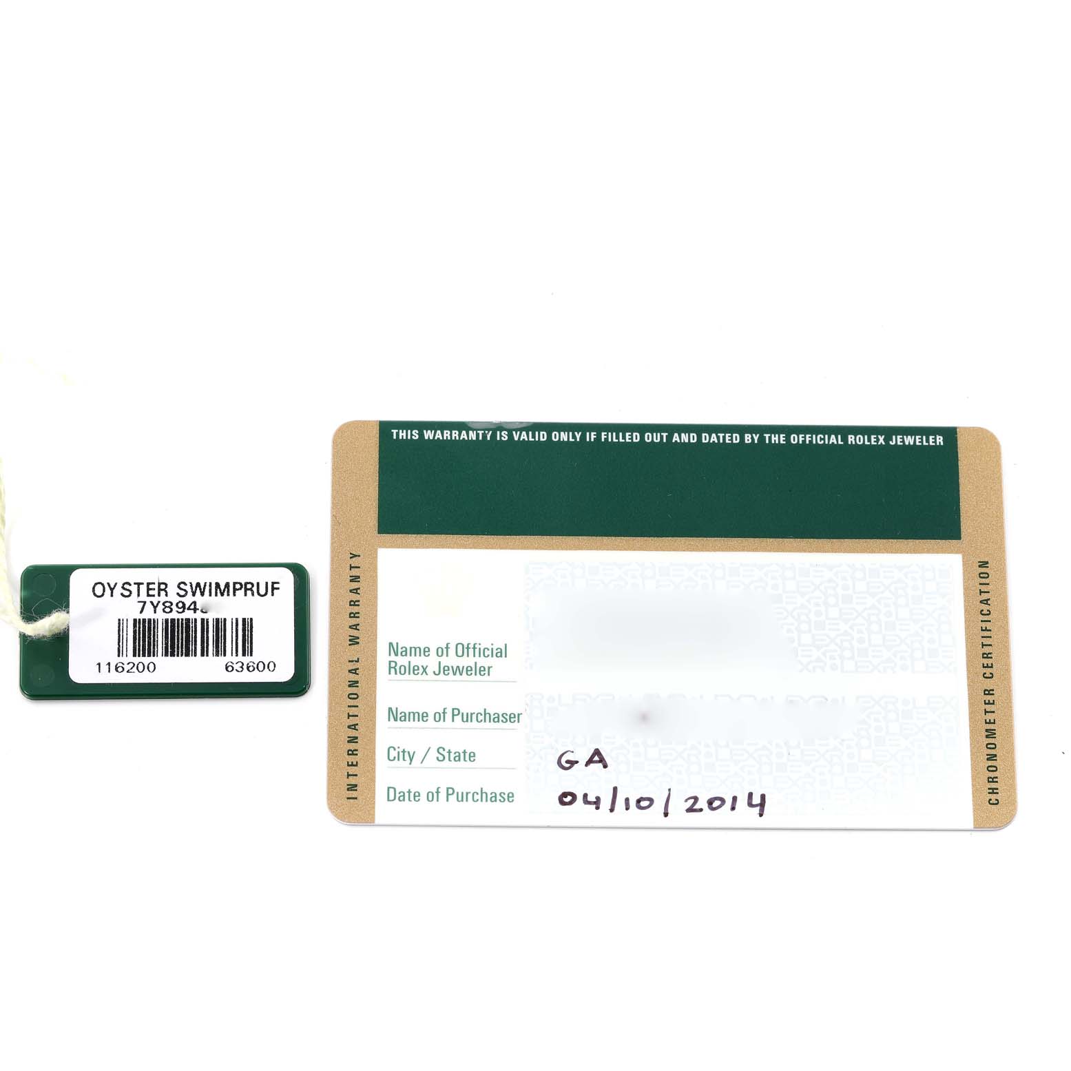 The image shows the warranty card and tag of a Rolex Datejust 116200 Men's Stainless Steel Blue Dial 116200 Men's Stainless Steel Blue Dial watch from an overhead angle.