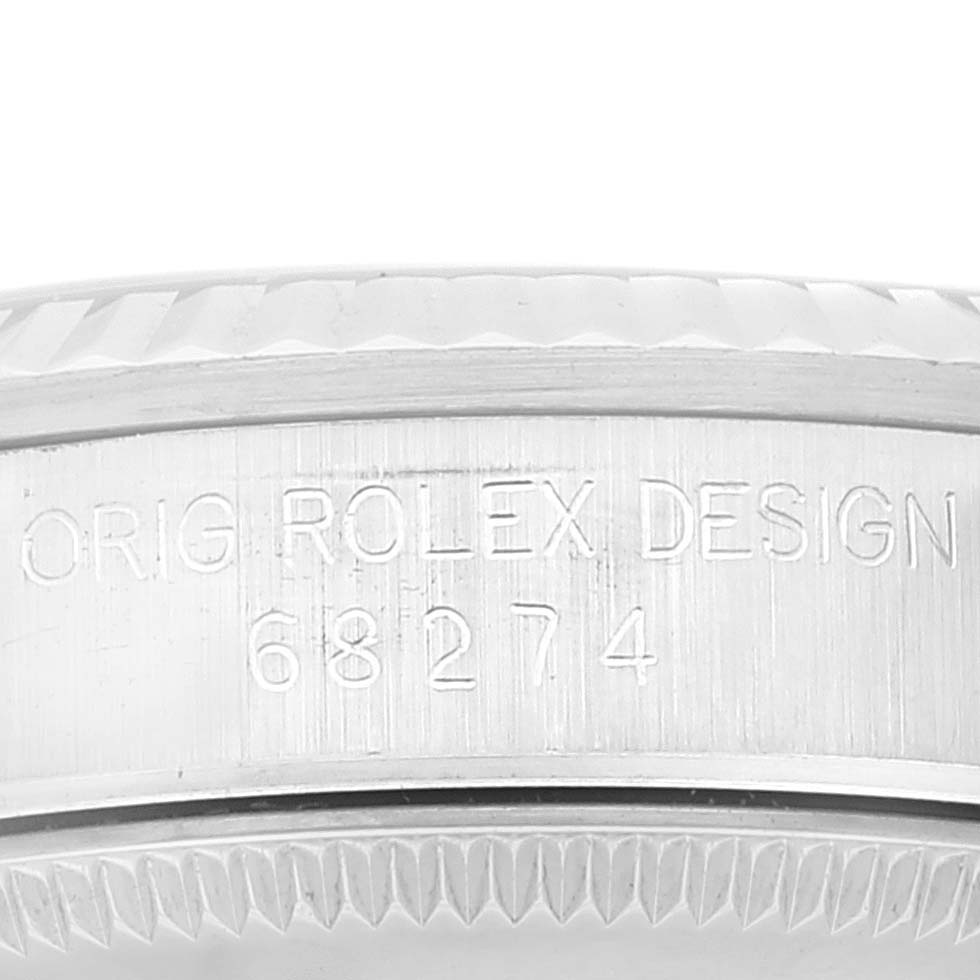 This image shows a close-up of the side and bezel engravings of a Mid-Size Rolex watch, model number 68274.