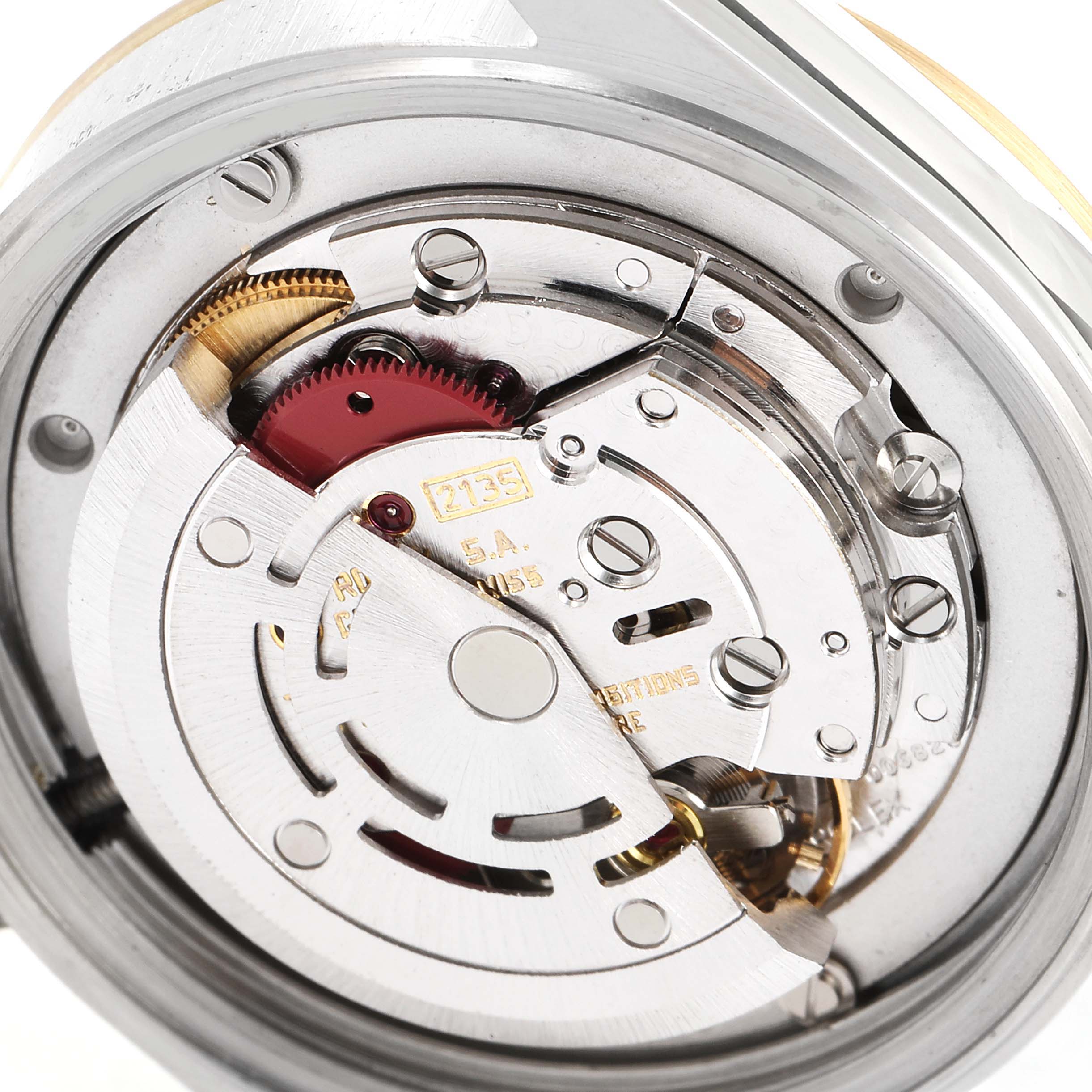 The image shows the intricate internal mechanism of a Rolex Mid-Size 68273 Women's Steel and Gold (two tone) Blue Dial 68273 Women's Steel and Gold (two tone) Blue Dial watch at a close-up angle.