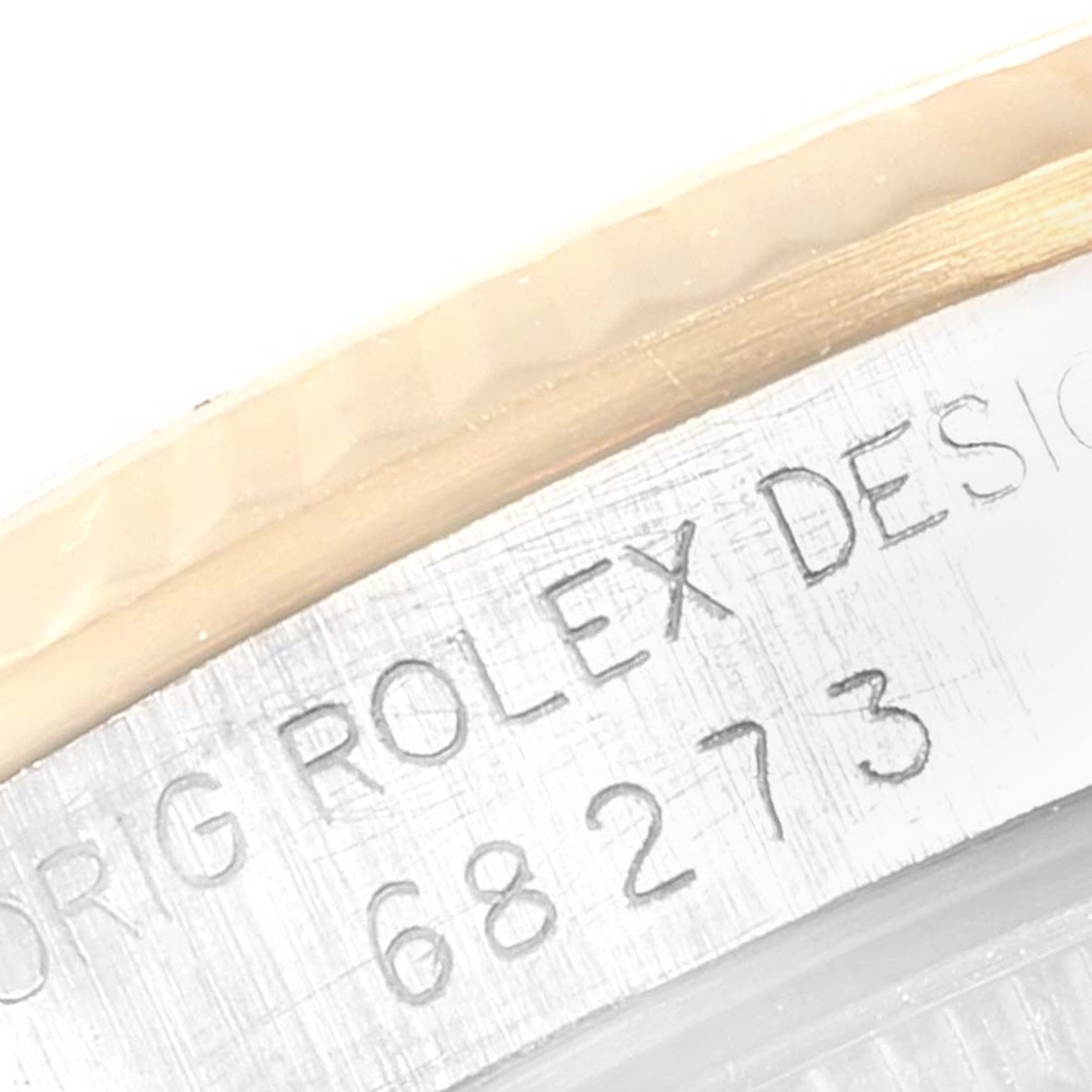 This image shows a close-up of the engraved model number on the case of a Mid-Size Rolex watch.