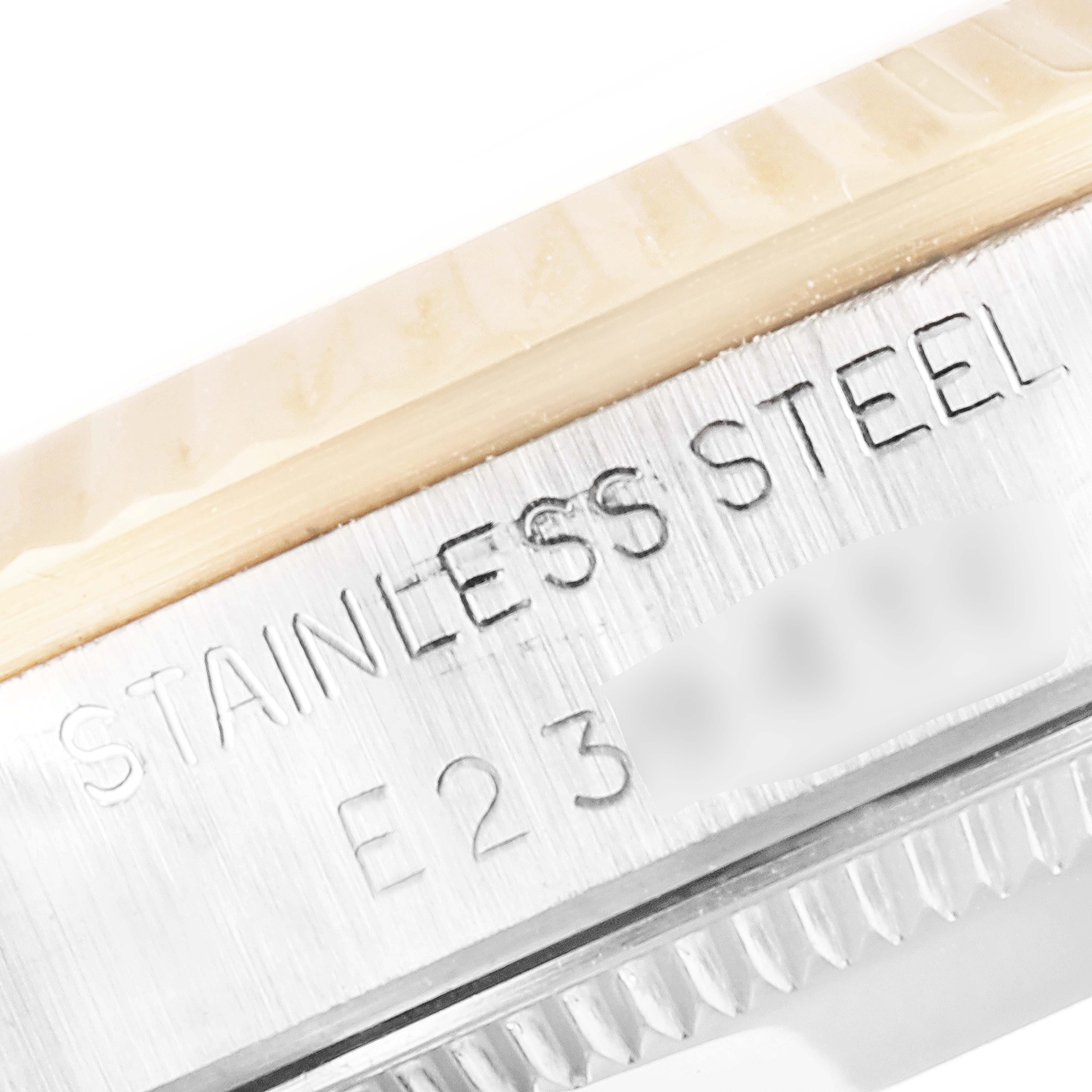 The image shows a close-up of the side of a stainless steel Rolex Mid-Size 68273 Women's Steel and Gold (two tone) Champagne Dial 68273 Women's Steel and Gold (two tone) Champagne Dial model watch, highlighting its case and engraved text.