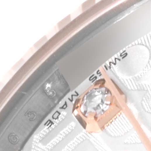 Close-up of a Rolex Mid-Size 178271 Women's Steel and Gold (two tone) Silver Dial 178271 Women's Steel and Gold (two tone) Silver Dial watch's gemstone hour marker, intricate dial, and part of the bezel.
