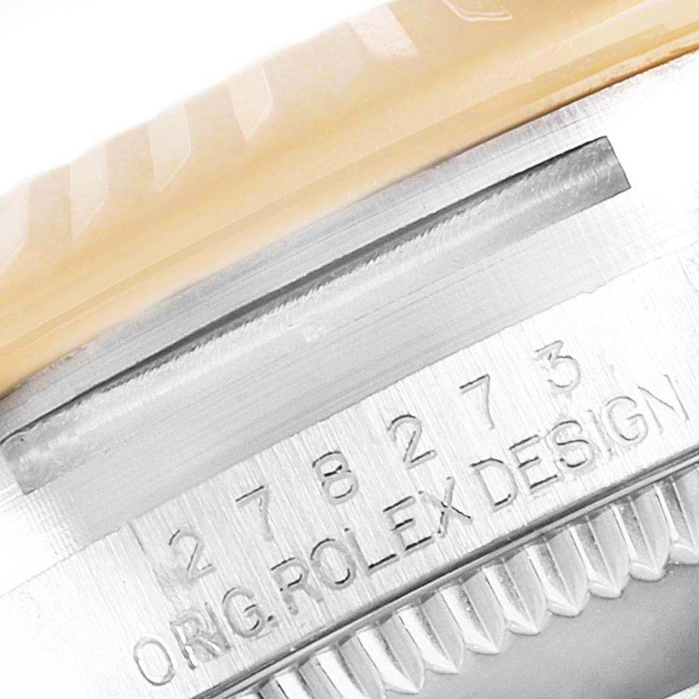 This close-up shot of a Mid-Size Rolex watch shows the engraved serial number and "ORIG ROLEX DESIGN" on the side of the case.