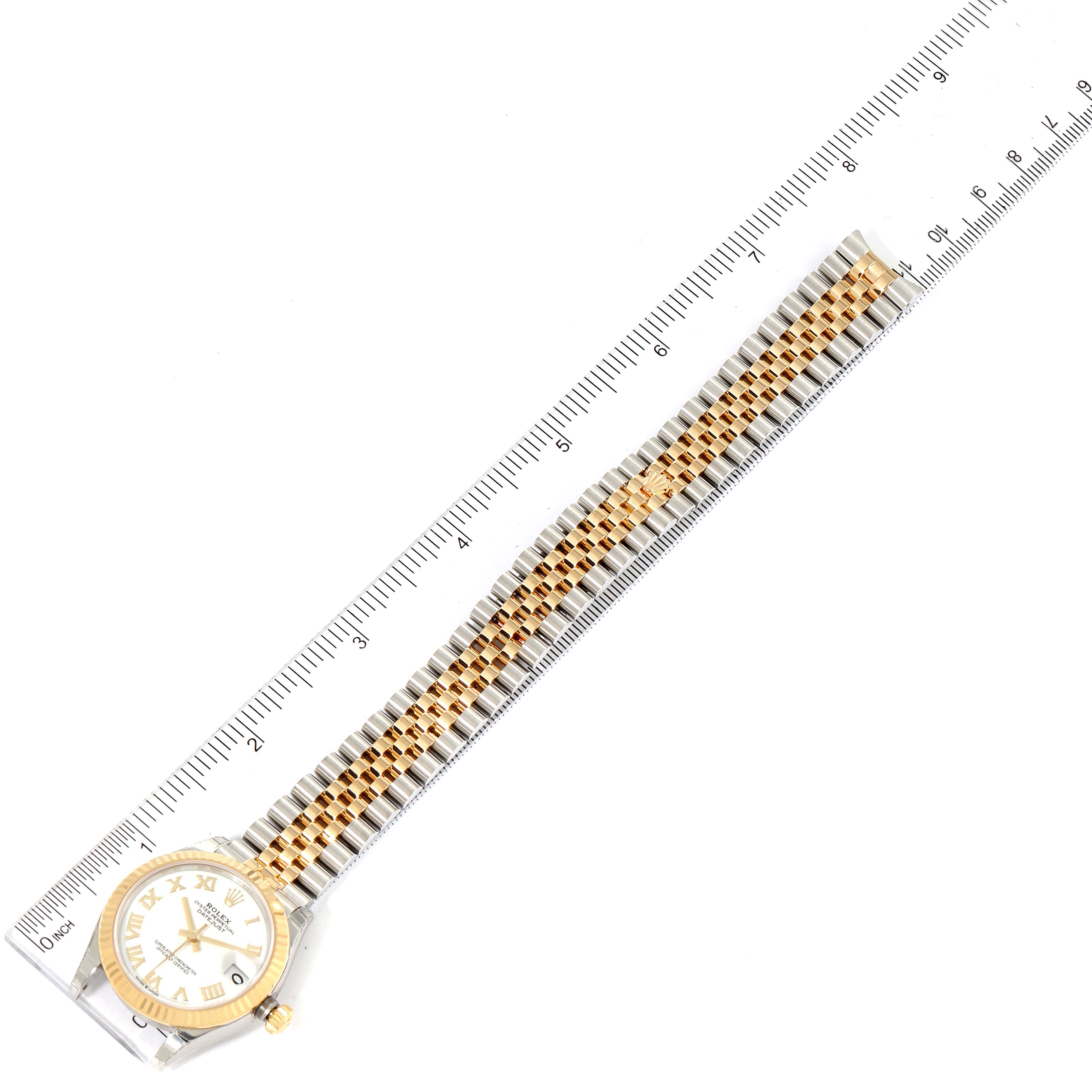 The Rolex Mid-Size 278273 Women
s Steel and Gold (two tone) White Dial 278273 Women
s Steel and Gold (two tone) White Dial watch is shown from a top-down angle, featuring its dial, bezel, and full bracelet measured against a ruler.