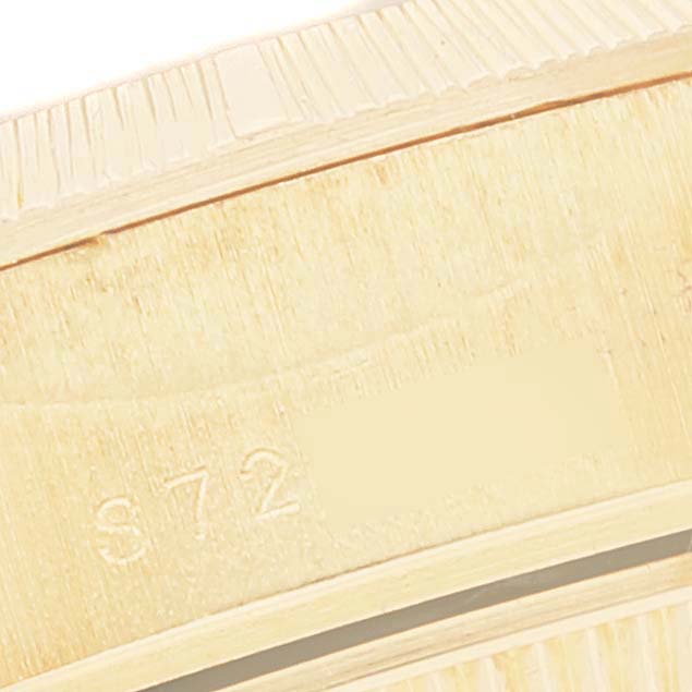 This close-up image shows the edge and part of the bracelet of a Rolex President 69278 Women
s Yellow Gold Champagne Dial 69278 Women
s Yellow Gold Champagne Dial watch, highlighting its engraved detail.