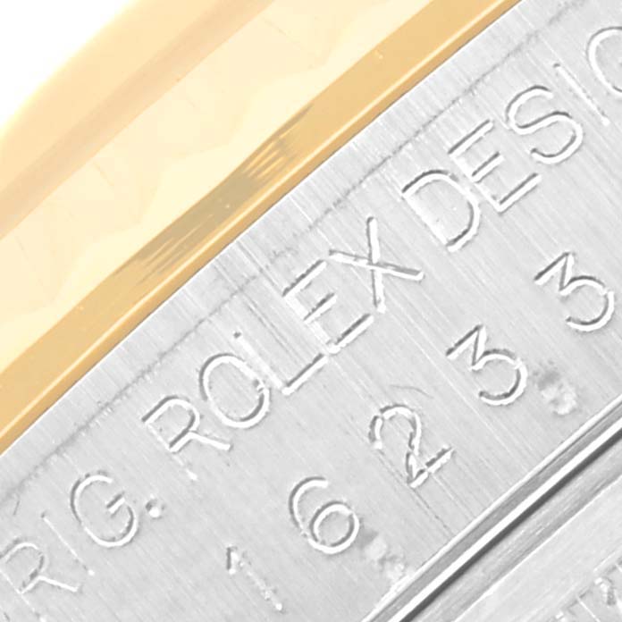 The image shows the engraved model details on the side of the case of a Rolex Datejust 16233 Men's Steel and Gold (two tone) Black Dial 16233 Men's Steel and Gold (two tone) Black Dial watch.