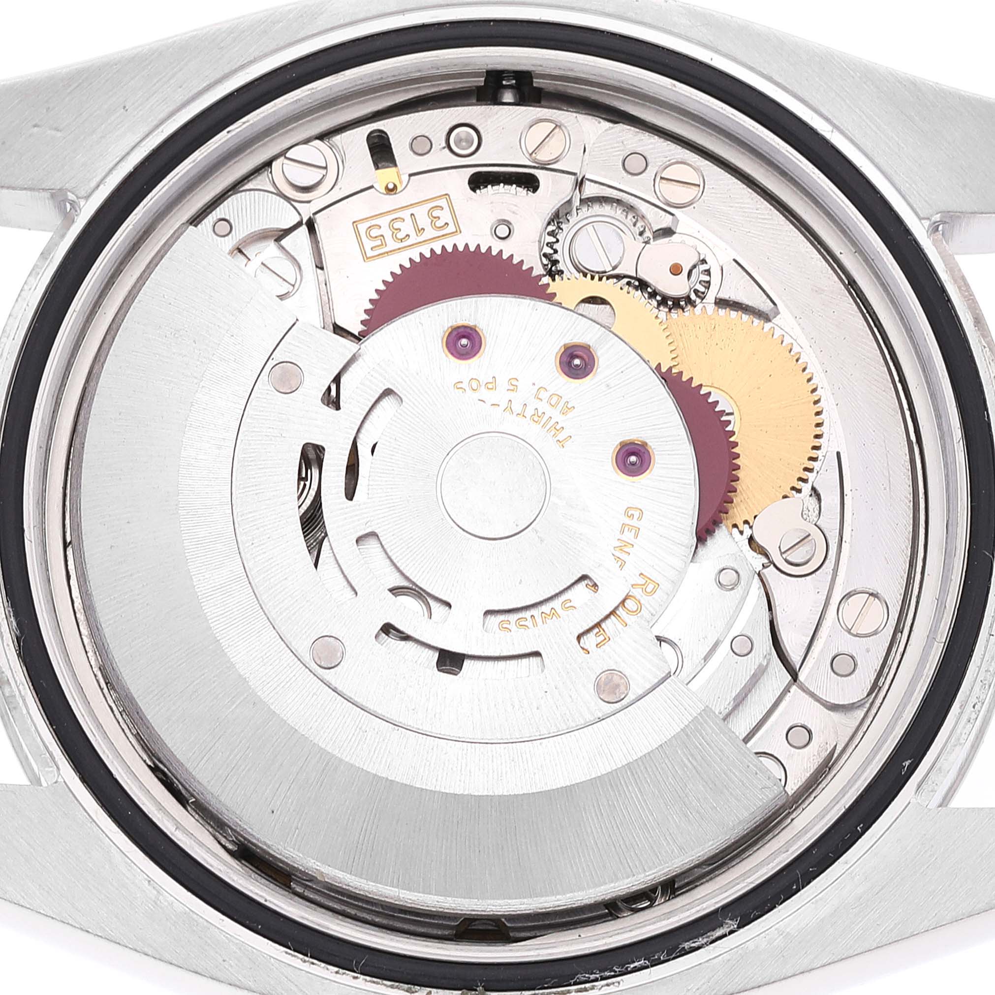 The image shows the caseback view of a Rolex Datejust 116234 Men's Stainless Steel Black Dial 116234 Men's Stainless Steel Black Dial watch, highlighting its intricate internal movement and components.