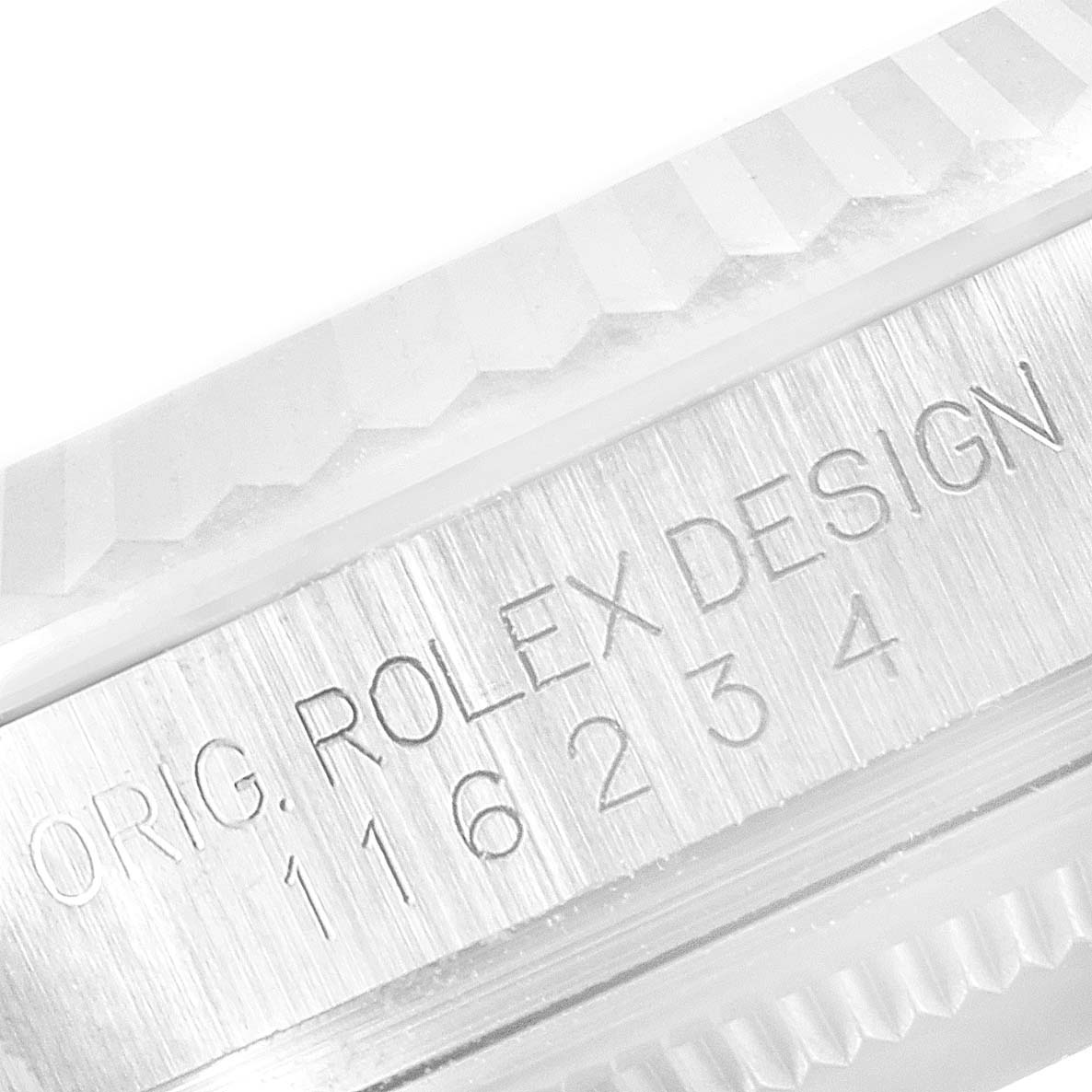 The image shows a close-up of the engraved case back and fluted bezel of a Rolex Datejust 116234 Men's Stainless Steel Black Dial 116234 Men's Stainless Steel Black Dial model.