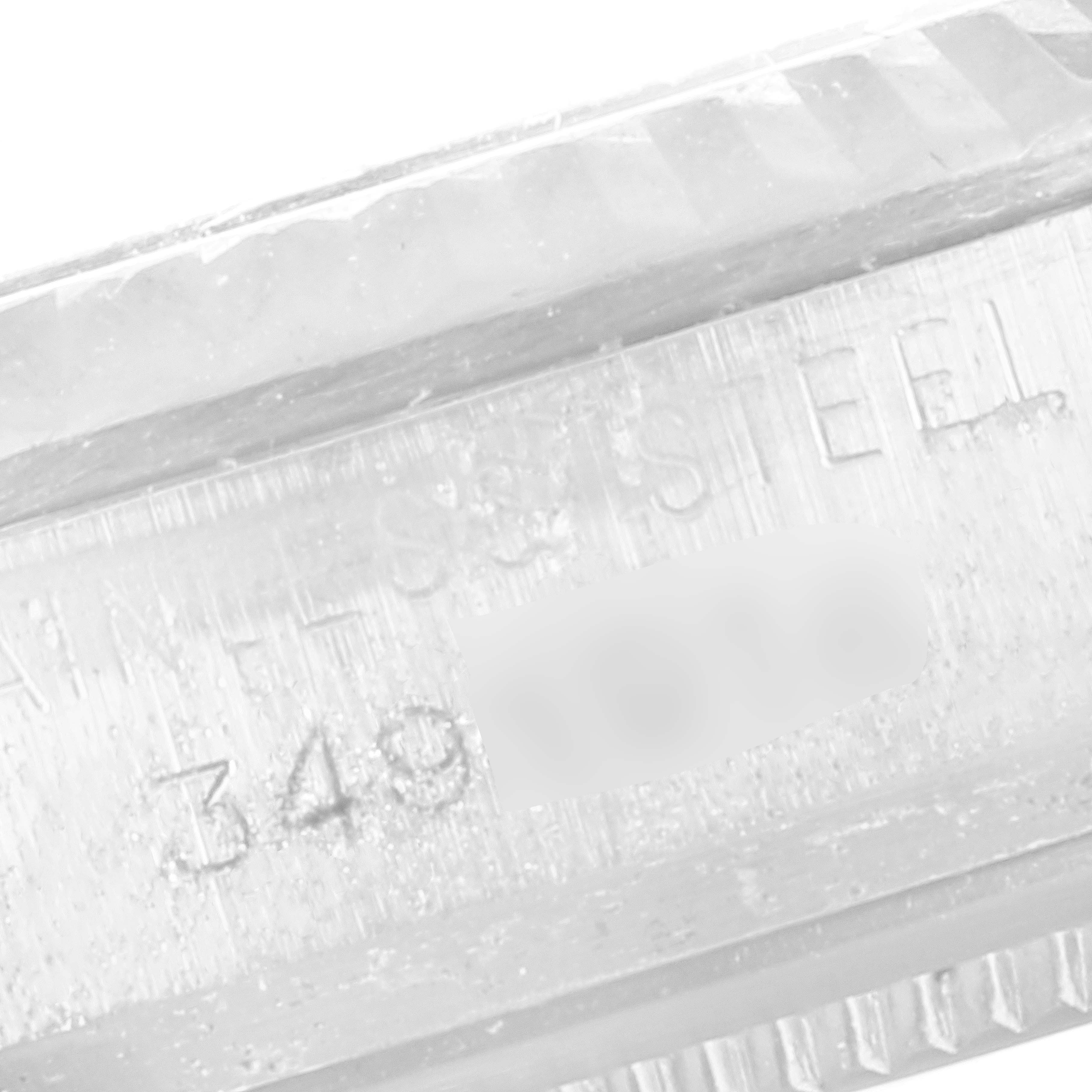 This image shows a close-up of the stainless steel casing with serial number engraving on the Rolex Vintage Collection 1601 Men's Stainless Steel Silver Dial 1601 Men's Stainless Steel Silver Dial watch.