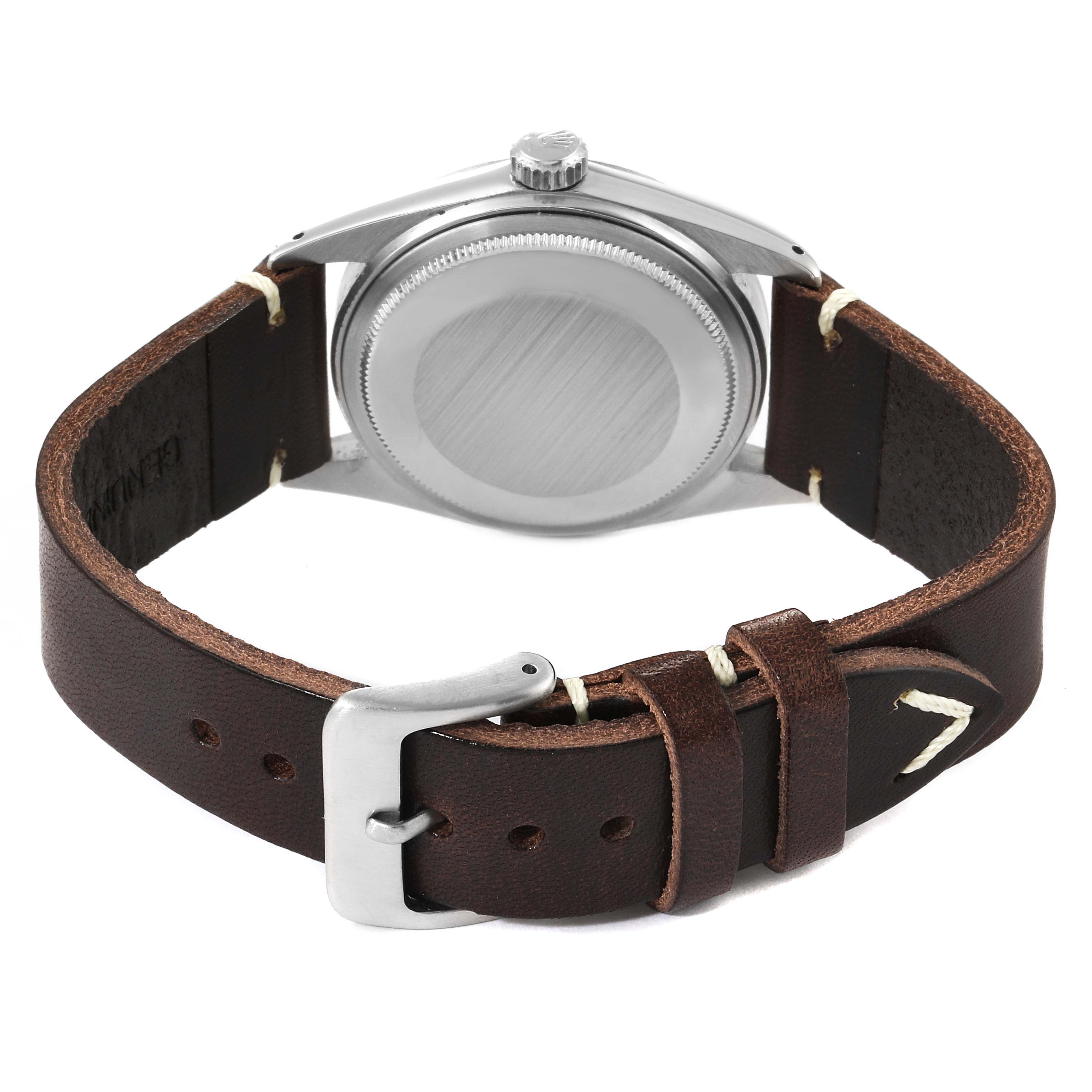 The image shows the back of the Rolex Vintage Collection 1601 Men's Stainless Steel Silver Dial 1601 Men's Stainless Steel Silver Dial model watch, highlighting its leather strap and stainless steel buckle.